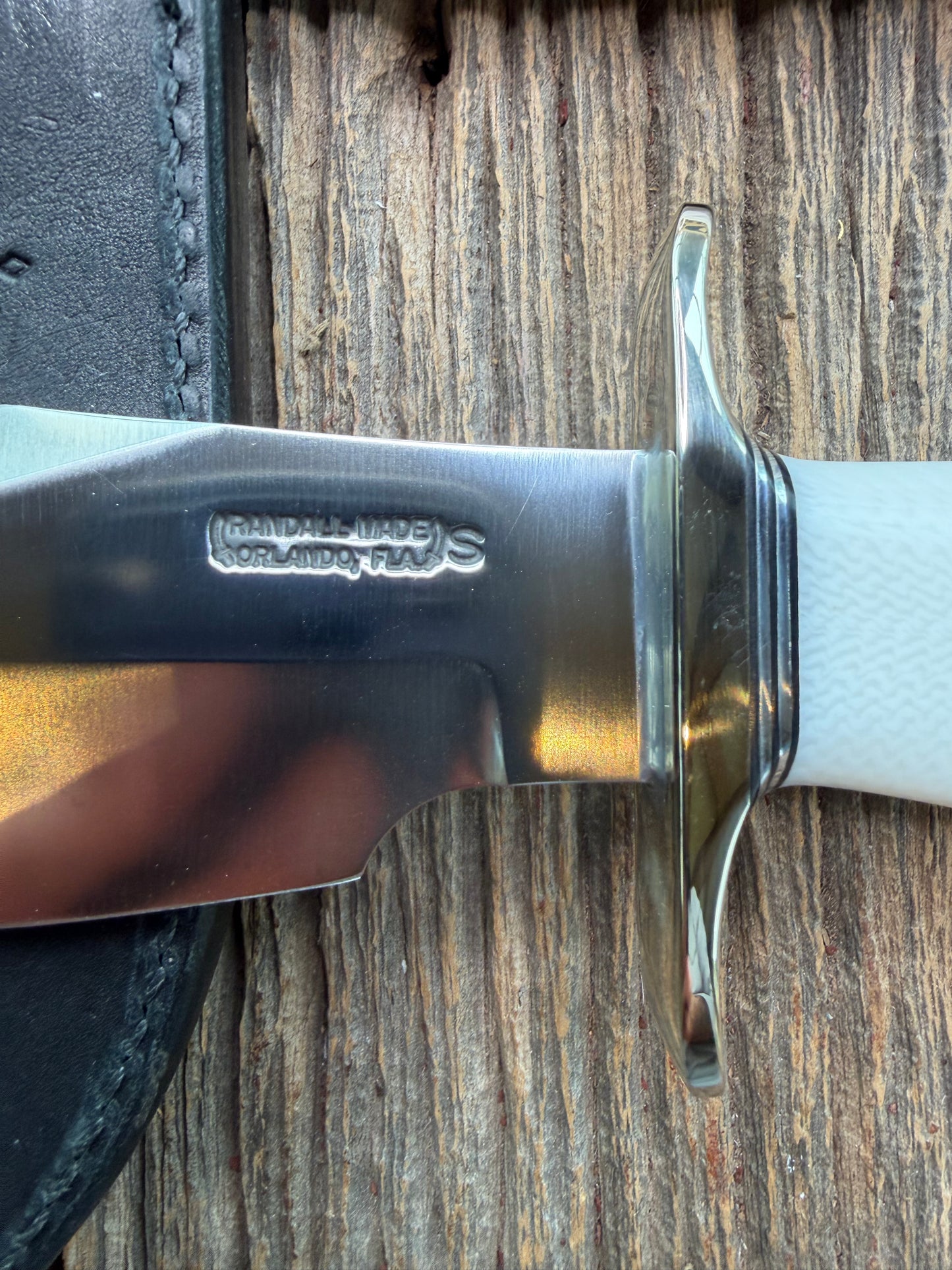 New in Paper Randall Model 19-5 Bushmaster with a White Ivorite handle. Stainless steel blade, Nickel silver hilt. Upgraded Black leather sheath. Crows Beak Aluminum handle.