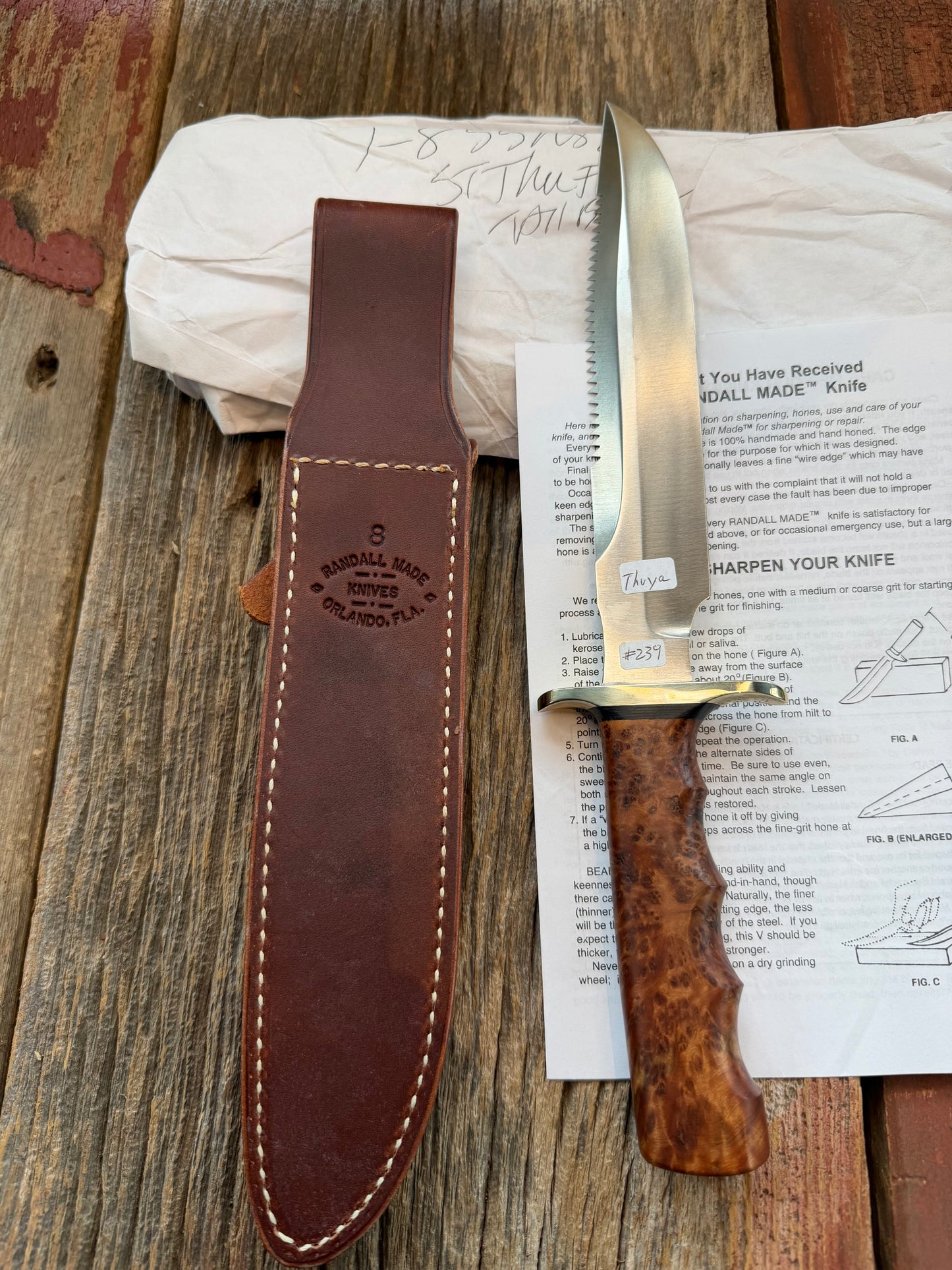 New in Paper Randall Made Knife Model 1-8 in Thuya wood. Stainless, single Black spacer, Sawteeth, Nickel Hilt.