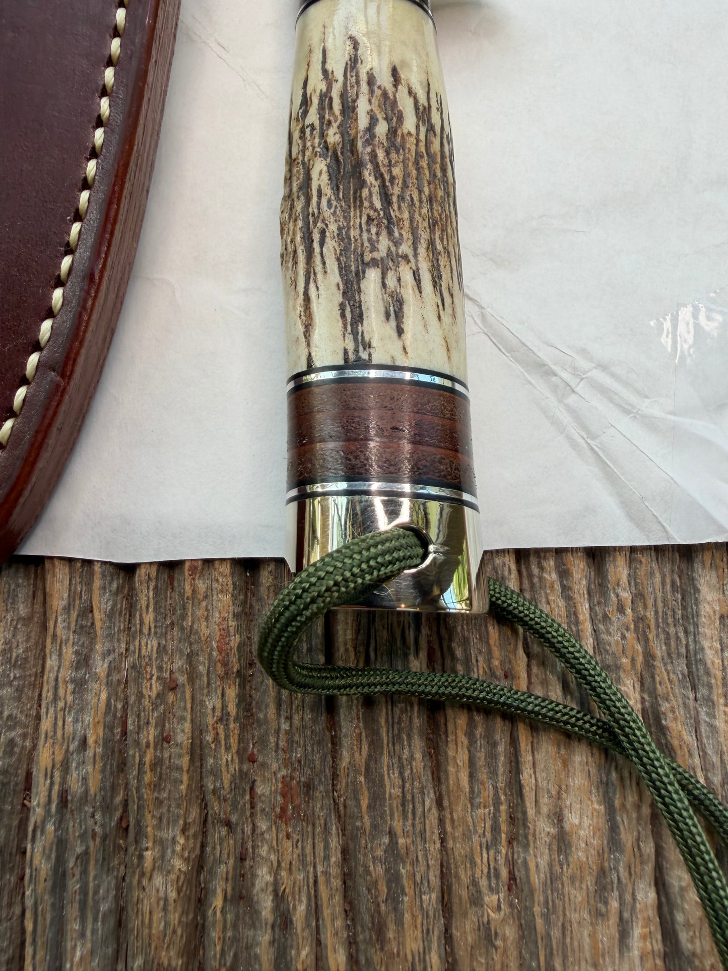 New in paper Randall Knife Model 26 Pathfinder. Stag, Black and Aluminum and leather spacers, Lanyard, NSH and buttcap.