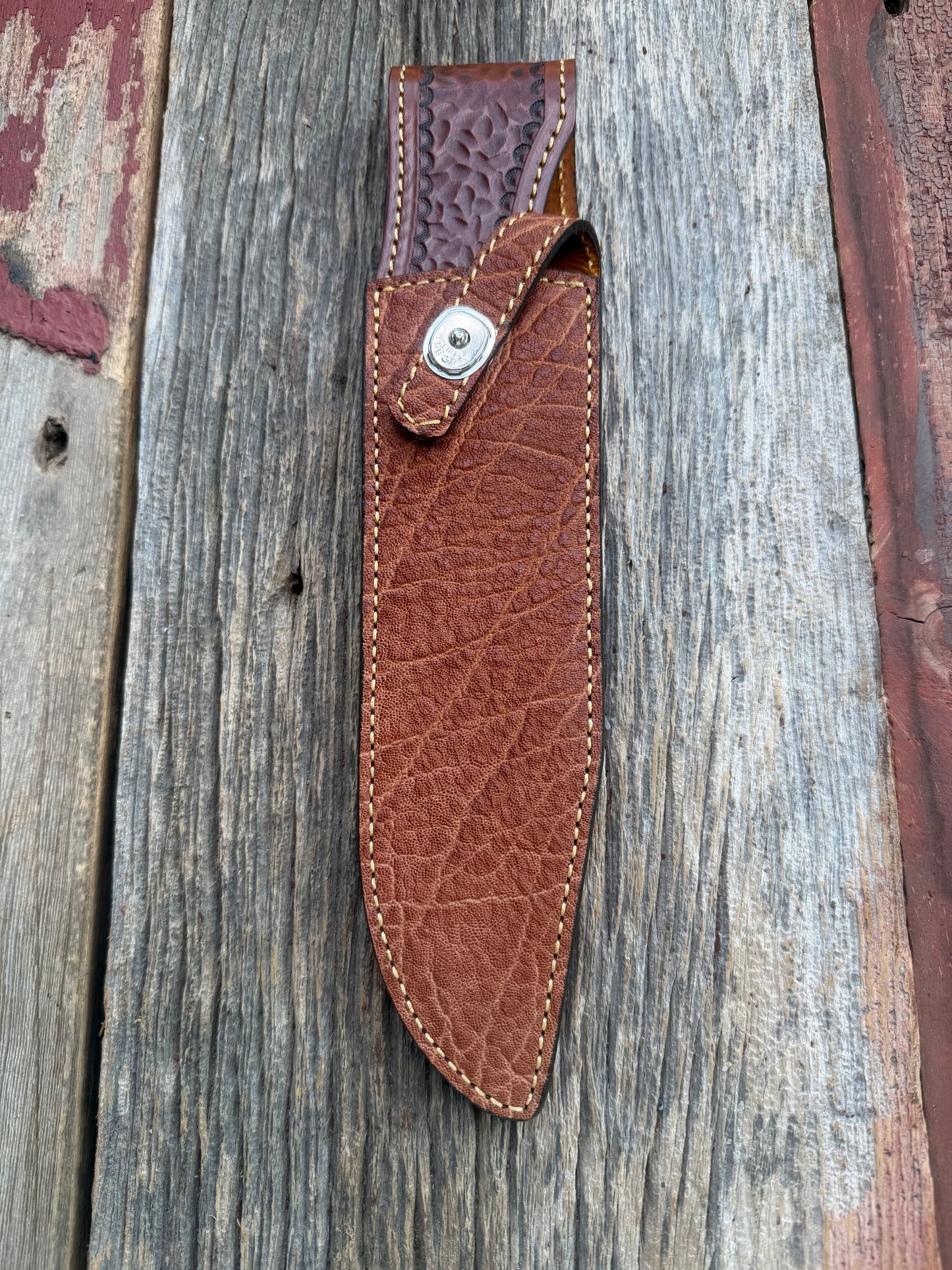 New Randall Model 12-9/14 Sheath in Exotic thick and textured Rust colored Elephant hide on brown leather from Treeman with a silver Canteen snap. Hand tooled belt loop. Killer sheath.
