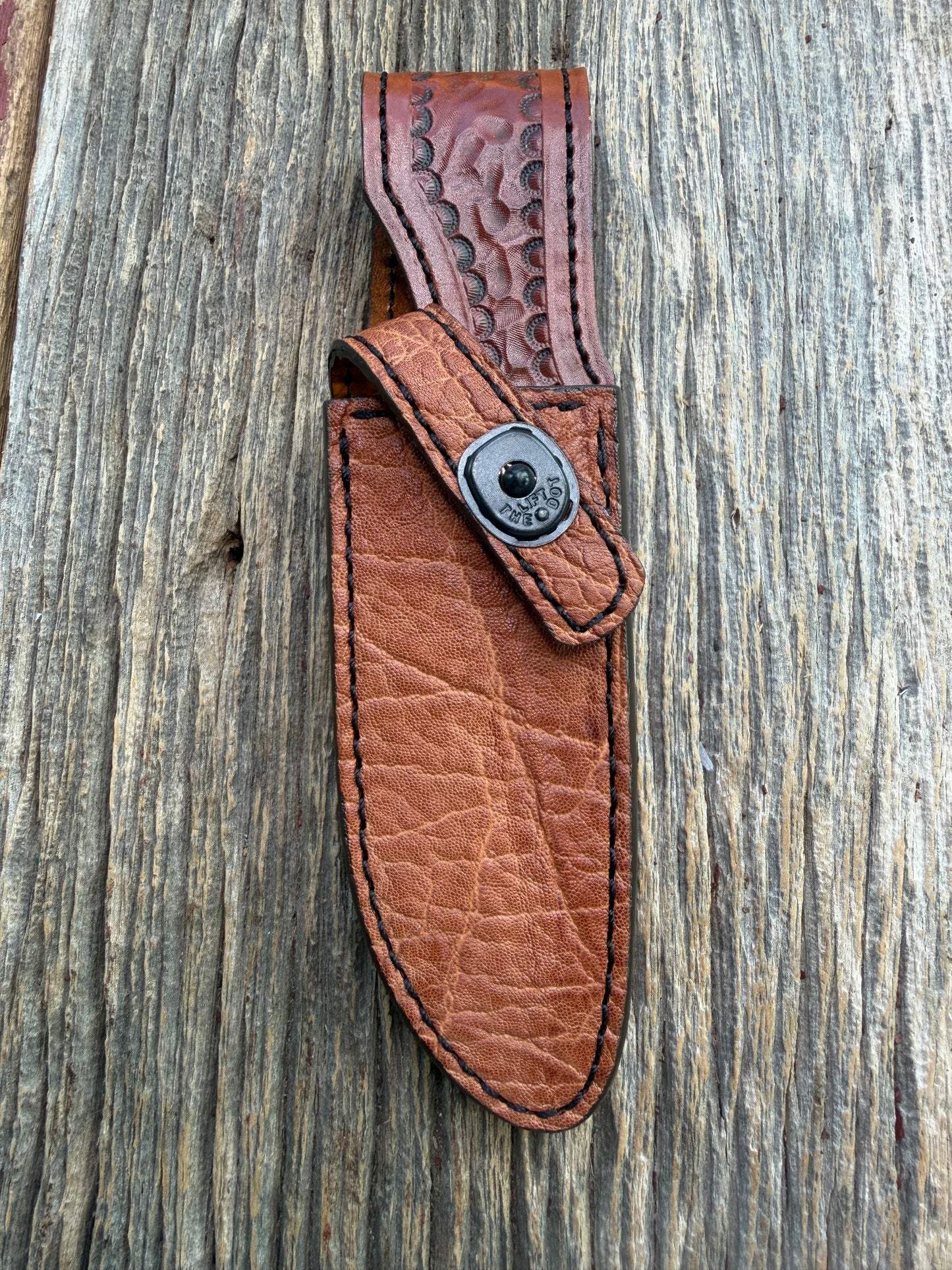 New Randall Model 23 Sheath in Exotic thick and textured Rust colored Elephant hide on brown leather from Treeman with a black Canteen snap. Hand tooled belt loop. Killer sheath.