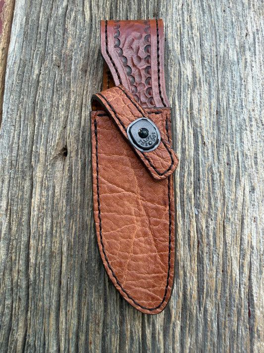 New Randall Model 23 Sheath in Exotic thick and textured Rust colored Elephant hide on brown leather from Treeman with a black Canteen snap. Hand tooled belt loop. Killer sheath.