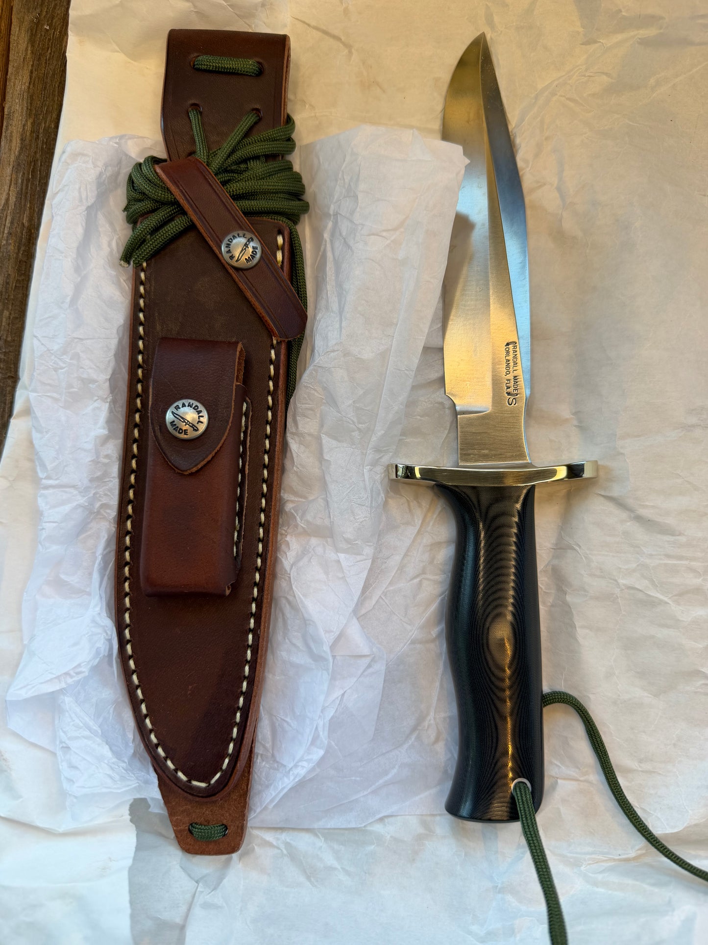 New in Paper Randall Model 16 SP#1 Special fighter with a Black Micarta handle. SS blade, Nickel silver Forward Curved hilt. Lanyard. Brown leather sheath.