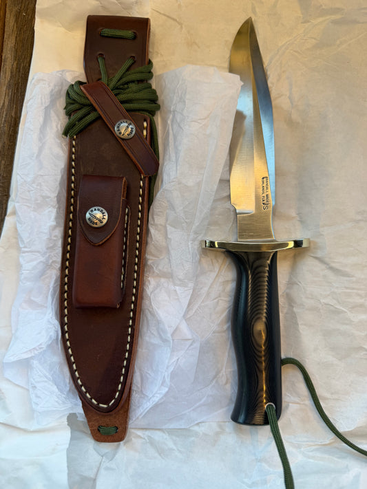 New in Paper Randall Model 16 SP#1 Special fighter with a Black Micarta handle. SS blade, Nickel silver Forward Curved hilt. Lanyard. Brown leather sheath.