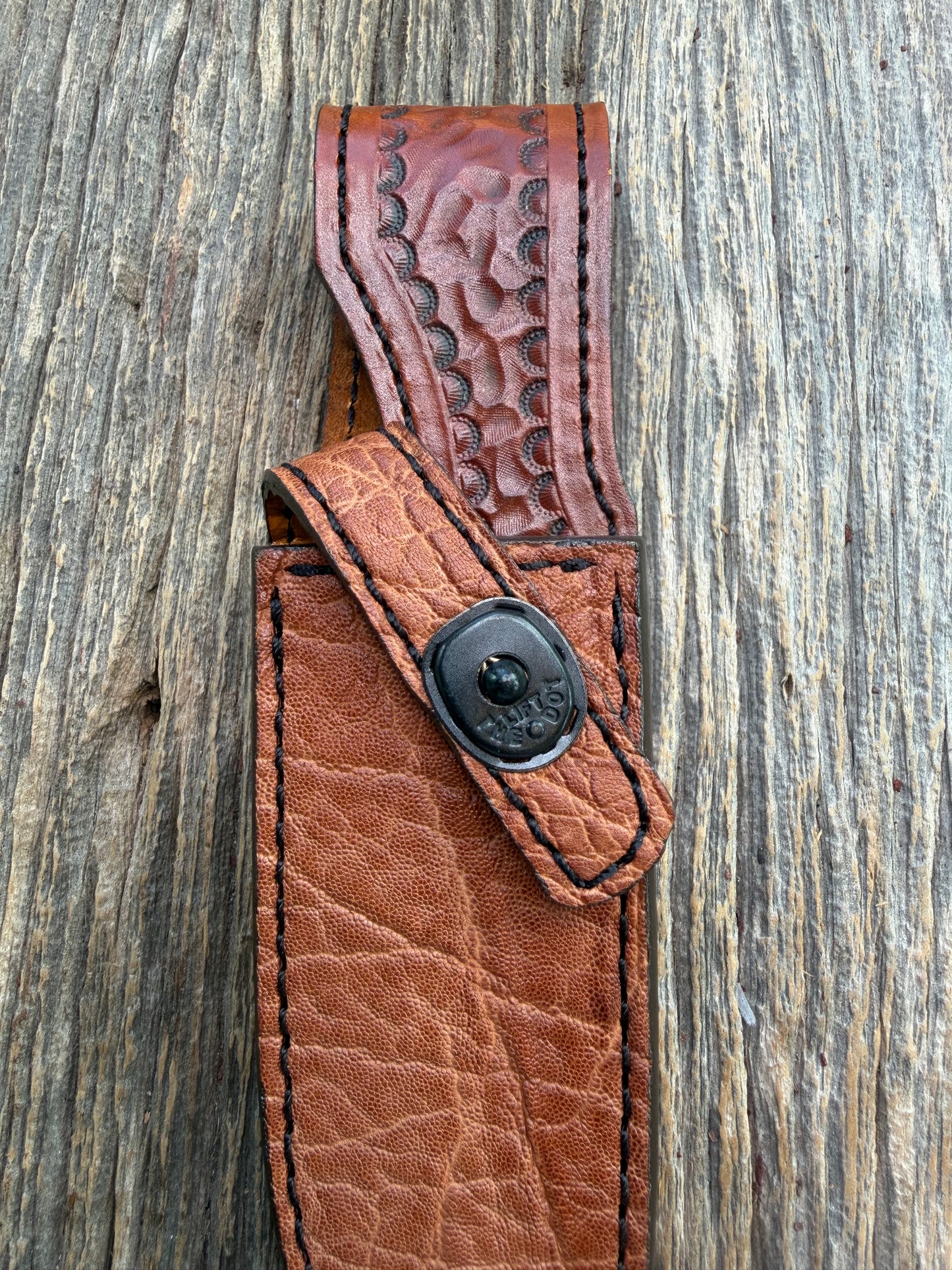 New Randall Model 23 Sheath in Exotic thick and textured Rust colored Elephant hide on brown leather from Treeman with a black Canteen snap. Hand tooled belt loop. Killer sheath.