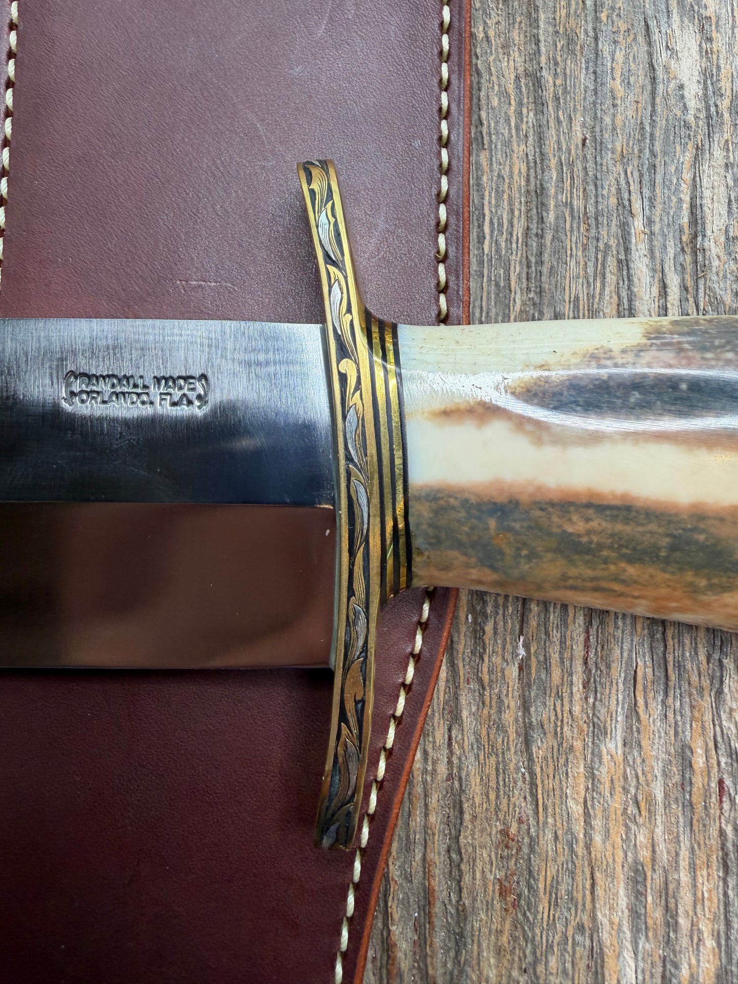 Randall Model 12-11 Smithsonian “Smitty” in a Huge piece of Green, Brown and Blue Fossil Walrus Ivory. Brass Hilt and Brass Butt plate fully engraved in Silver from Jere Davidson.  Stunning piece.