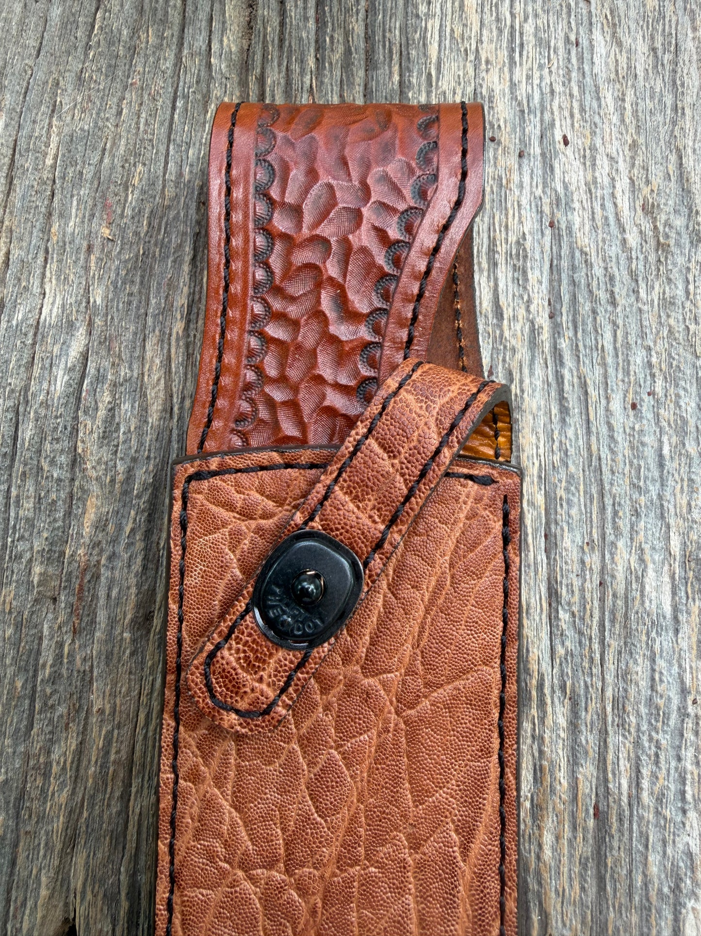 New Randall Model 12-9/14 Sheath in Exotic thick and textured Rust colored Elephant hide on brown leather from Treeman with a black Canteen snap. Hand tooled belt loop. Killer sheath.