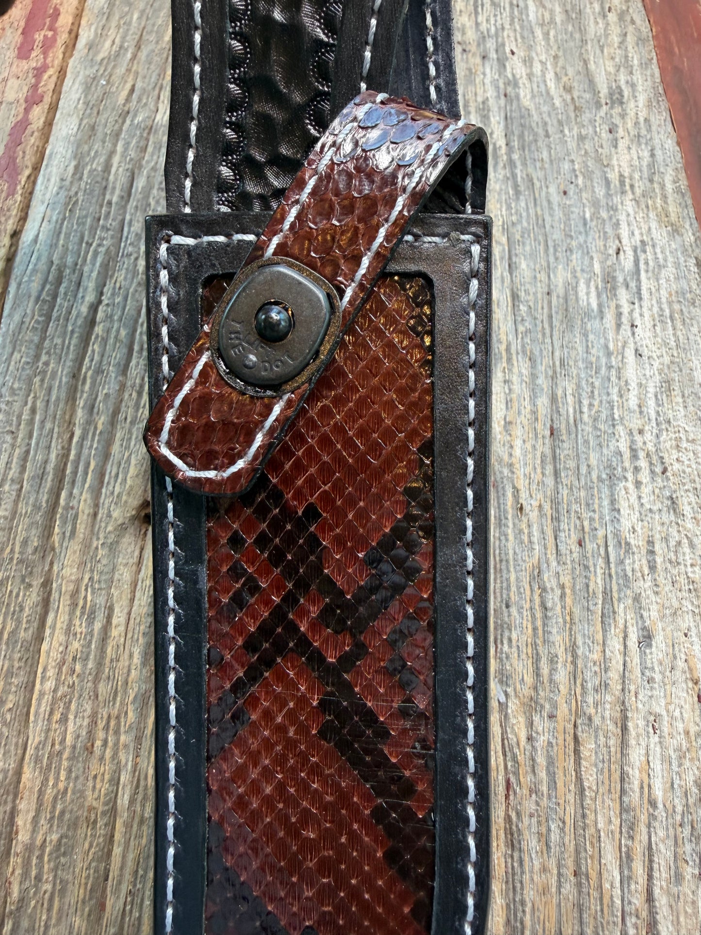 New Randall Model 1-8 Sheath in Exotic Brown Python Snake skin on black leather from Treeman with a black Canteen snap. Hand tooled belt loop. Deviated white stitching. Killer sheath.