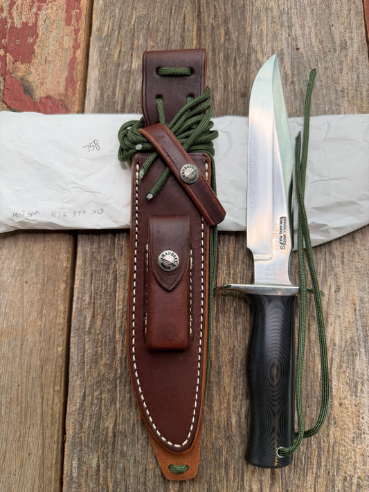 New in Paper Randall Model 16 SP#1 Special fighter with a Black Micarta handle. SS blade, Nickel silver hilt. Lanyard. Brown leather sheath.
