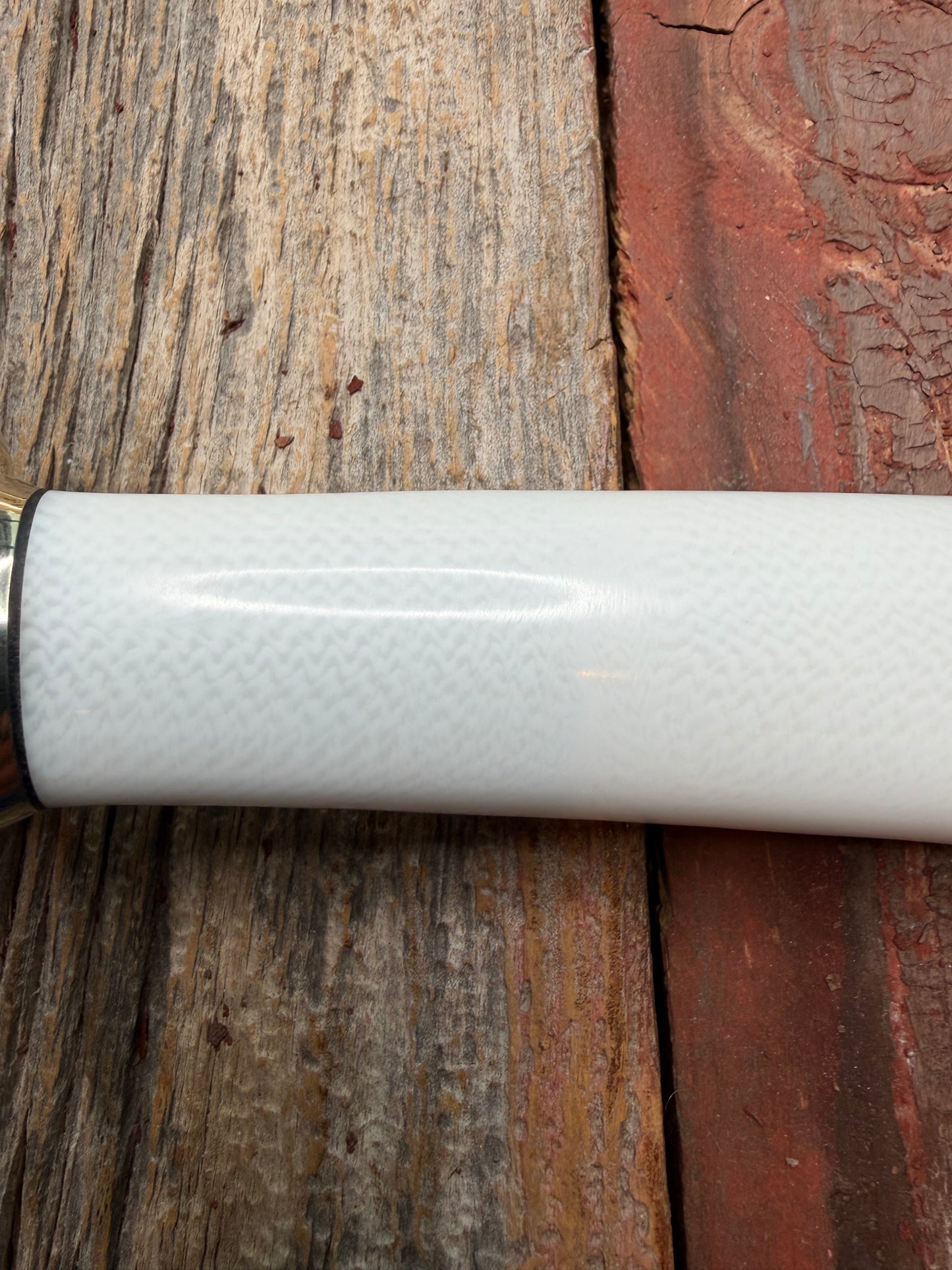 Randall Model 14-7.5 with a White Ivorite handle. Stainless steel blade, Nickel silver hilt and collar. Upgraded Black leather sheath.  Roundsd Aluminum butt cap.