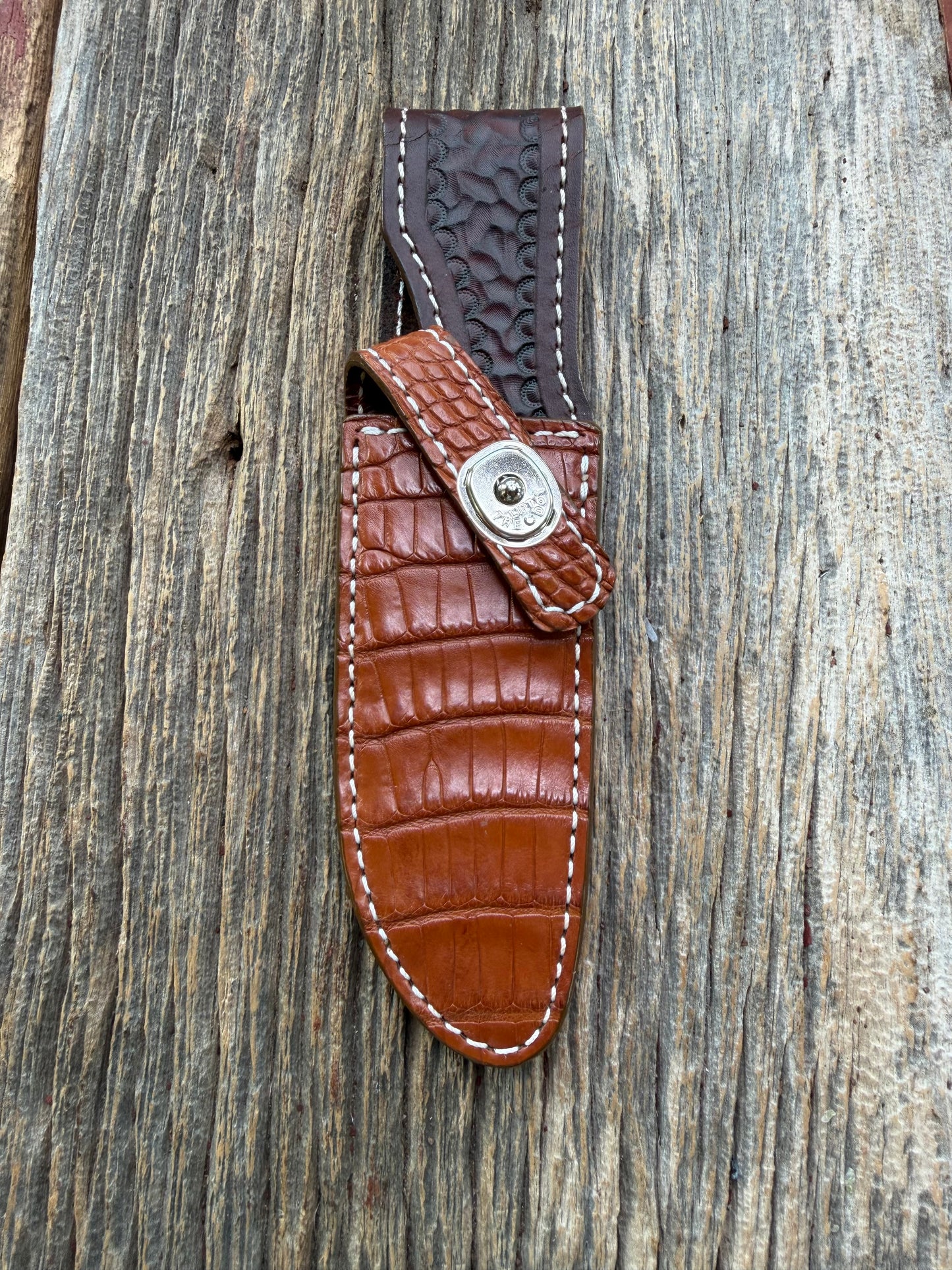 New Randall Model 23 Sheath in Exotic thick and textured Honey Crocodile skin on brown leather from Treeman with a silver Canteen snap. Hand tooled belt loop. Killer sheath.