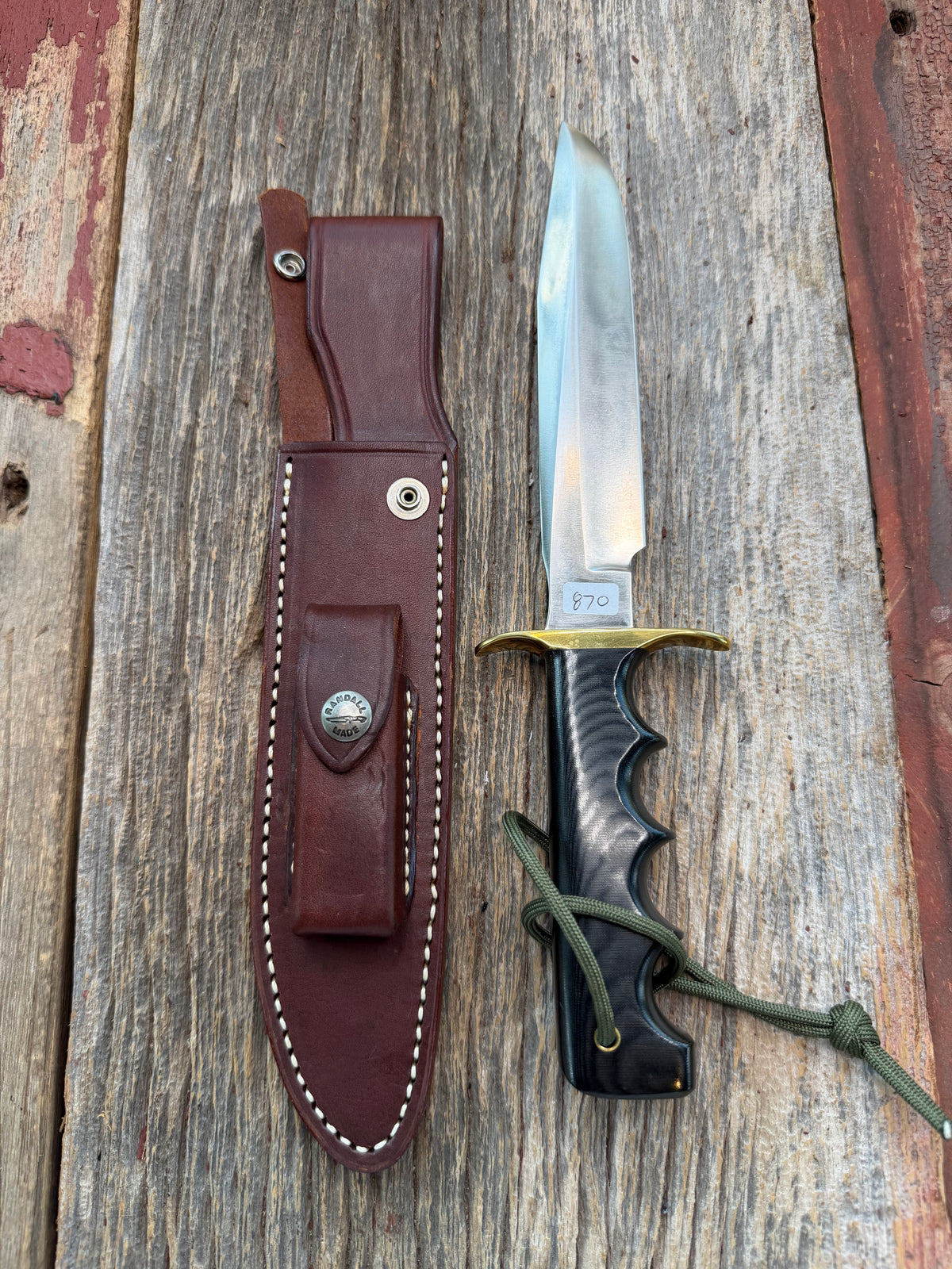 New in paper Randall Model 16 SP#1 Special fighter with a Black Micarta handle. SS blade, brass hilt. Lanyard. Brown leather sheath.