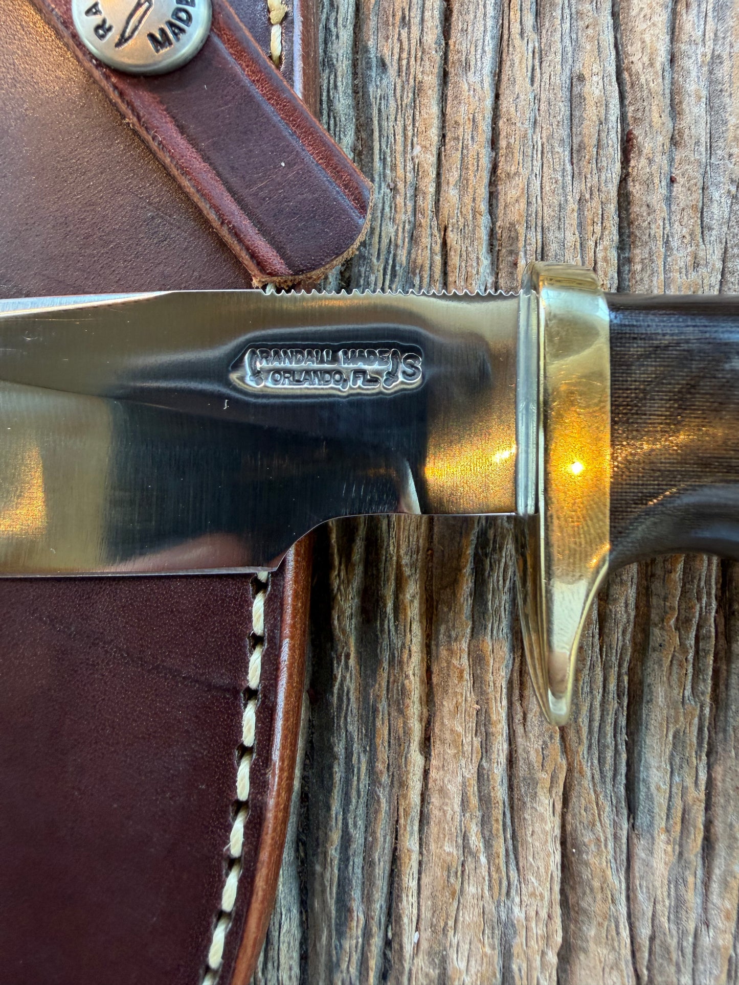 Nice Randall Model 28 Woodsman in Black Micarta. SS blade, brass single hilt. Lanyard. Brown leather sheath.