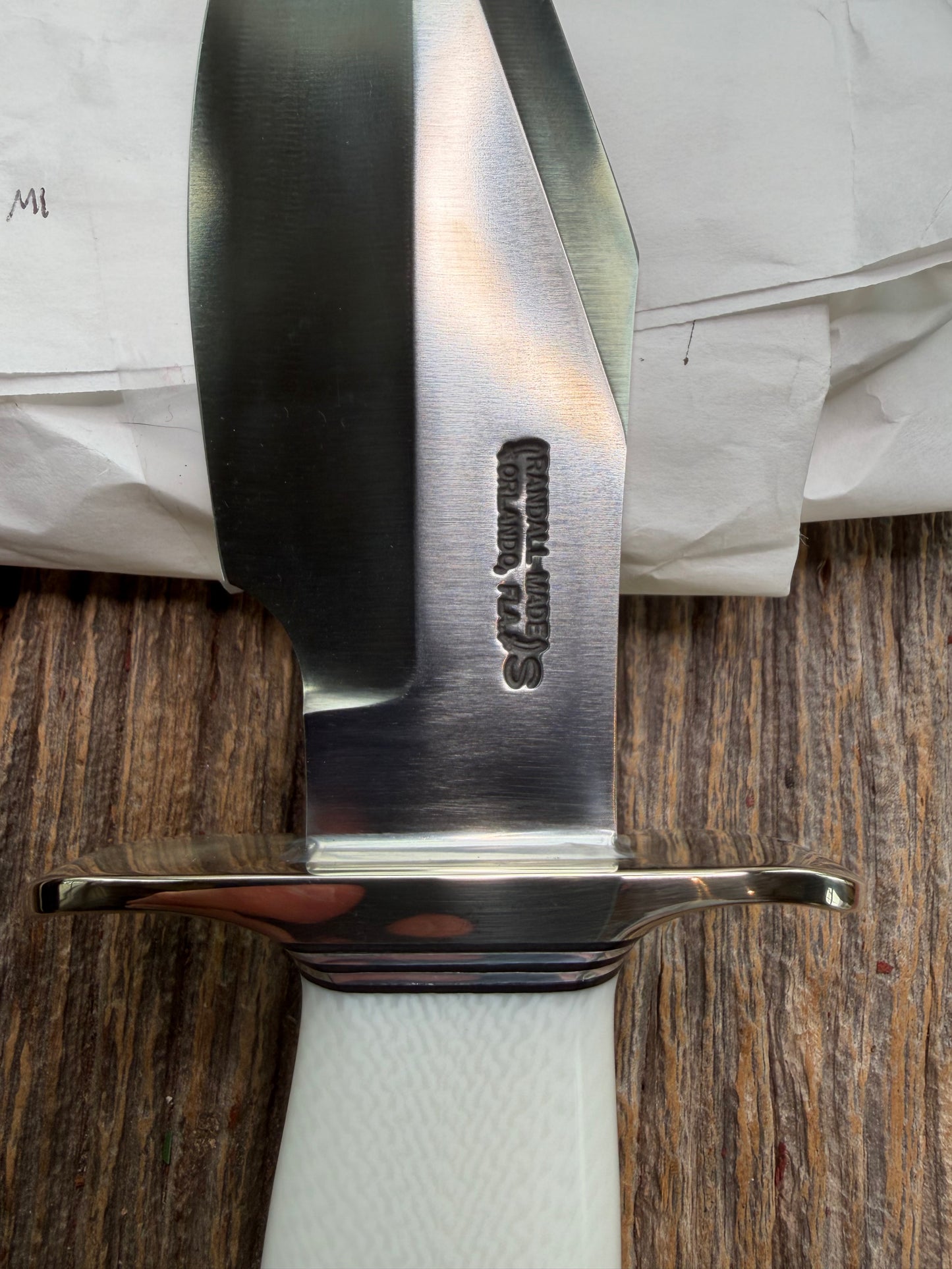 New in Paper Randall Model 19-5 Bushmaster with a White Ivorite handle. Stainless steel blade, Nickel silver hilt. Upgraded Black leather sheath. Crows Beak Aluminum handle.
