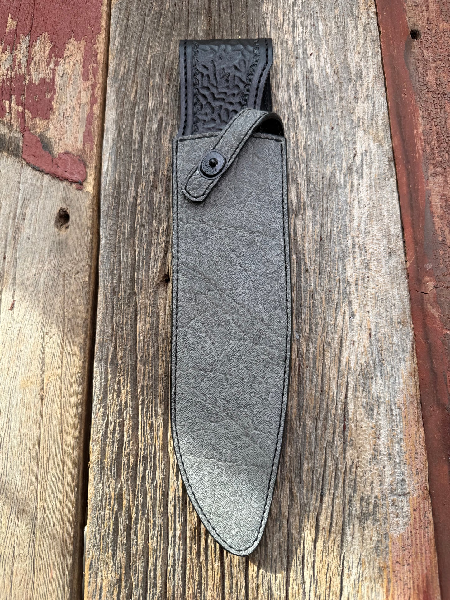 New Randall Model 12-11 Large Sasquatch Sheath in Exotic thick and textured Grey Elephant Hide on black leather from Treeman with a black Canteen snap. Hand tooled belt loop. Killer sheath.