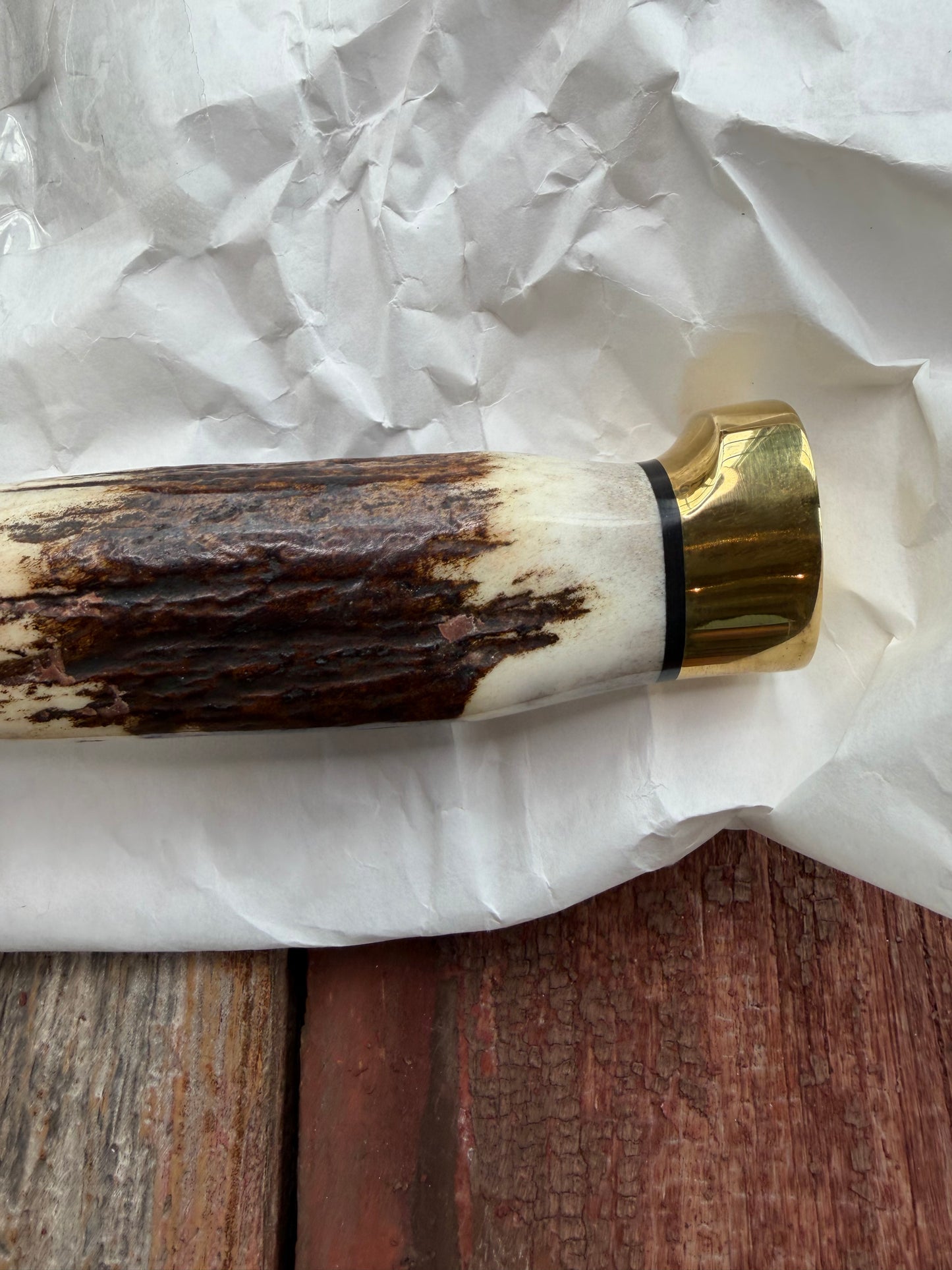 New in paper fresh from the Shop. Randall Knife Model 14-7.5 Big. Nice piece of Stag, Gorgeous Brass Lugged hilt and brass crows beak butt cap. Single black spacer. Stainless steel.