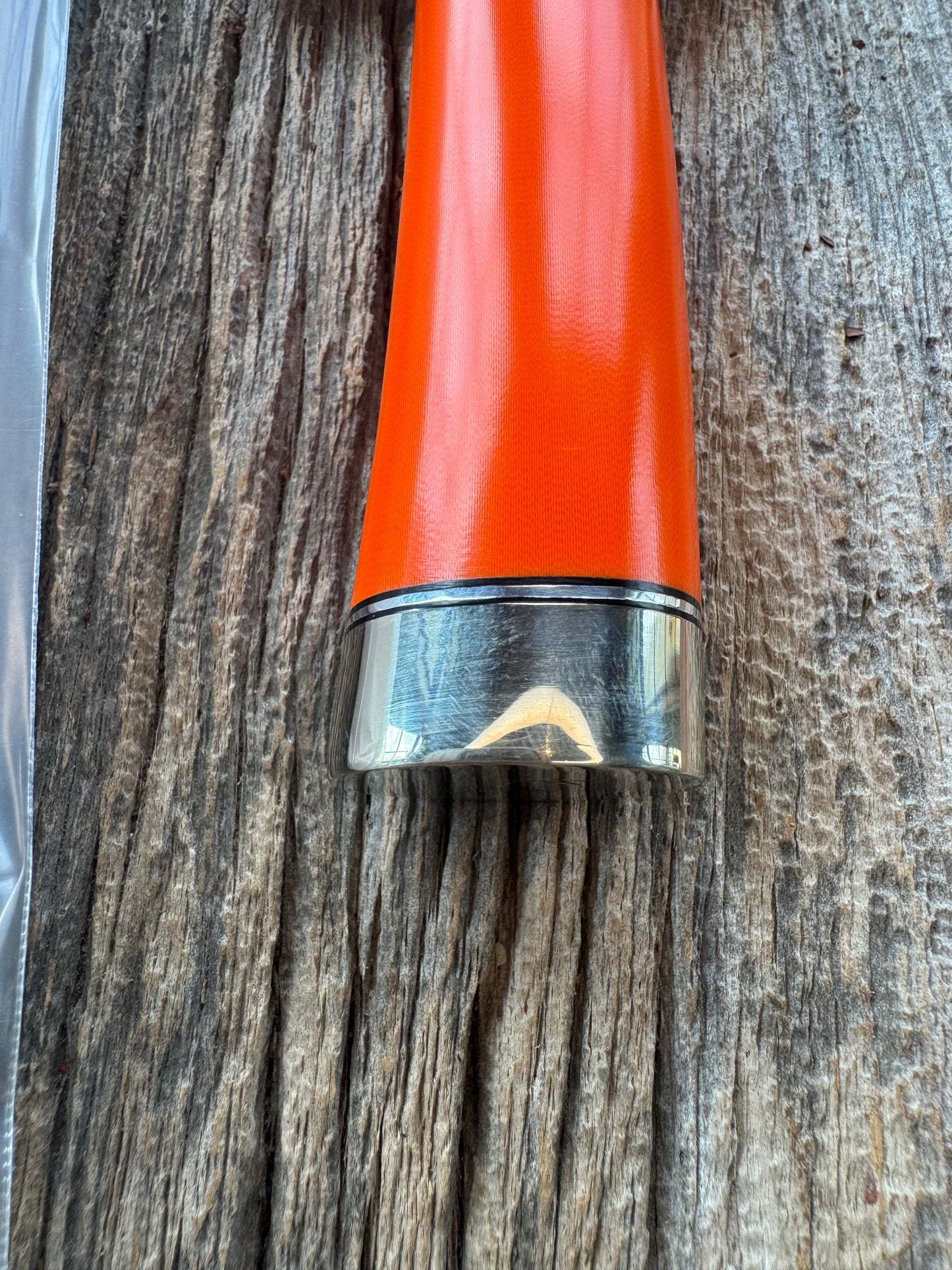 New in paper Randall Model 14 CDT with a nice piece of customer supplied Orange G10. Stainless Steel, Nickel Silver Hilt and Butt cap.
