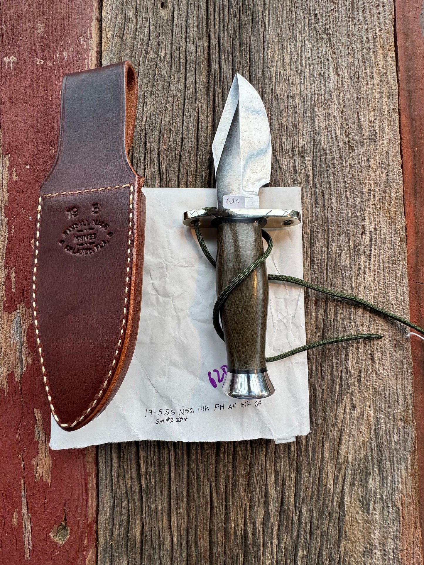 New in Paper Randall Model 19-5 Bushmaster with an Green Micarta handle. SS blade, Nickel silver single hilt. Lanyard. Brown leather sheath.