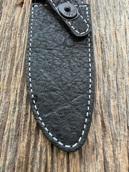 New Randall Model 11-5 Sheath in Exotic thick and textured Black Elephant hide on black leather from Treeman with a black Canteen snap. Hand tooled belt loop. Killer sheath.