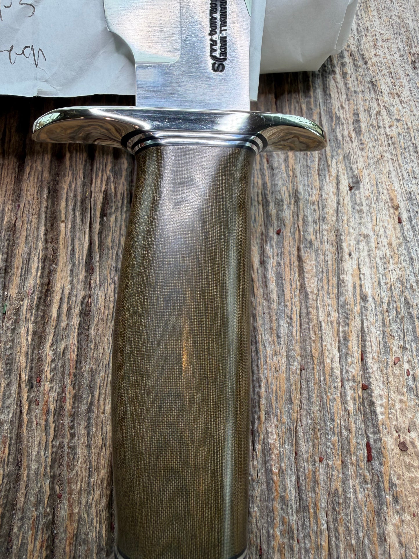 New in Paper Randall Model 19-5 Bushmaster with a Green Micarta handle. Stainless steel blade, Nickel silver hilt. Brown leather sheath. Crows Beak Aluminum handle.