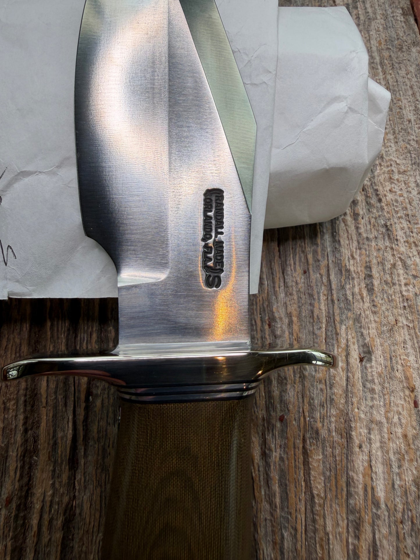 New in Paper Randall Model 19-5 Bushmaster with a Green Micarta handle. Stainless steel blade, Nickel silver hilt. Brown leather sheath. Crows Beak Aluminum handle.