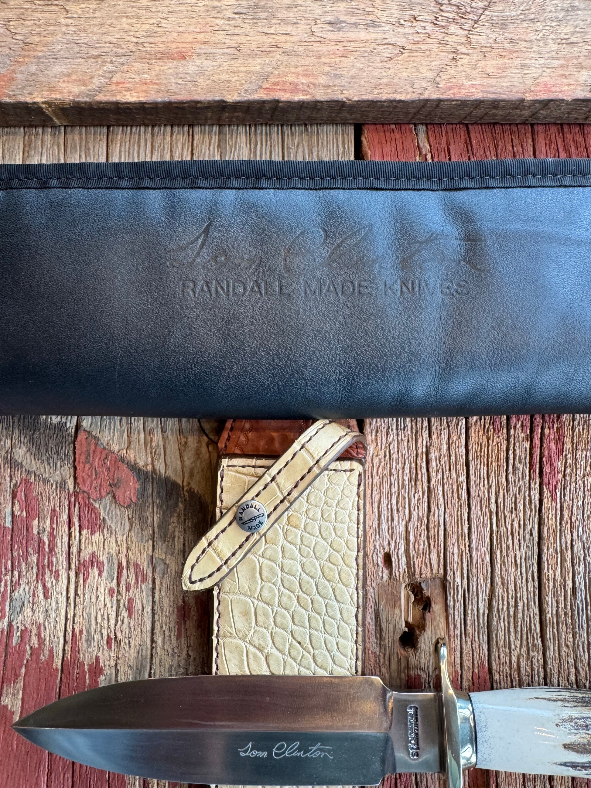 Randall Tom Clinton Dealer Special. Clinton Blade etched Commemorative 1/100 in a nice piece of Stag. Very cool Ostrich Gutcher sheath. Nickel Silver Hilt and Nickel Butt cap. Included in black facsimile Tom Clinton case.