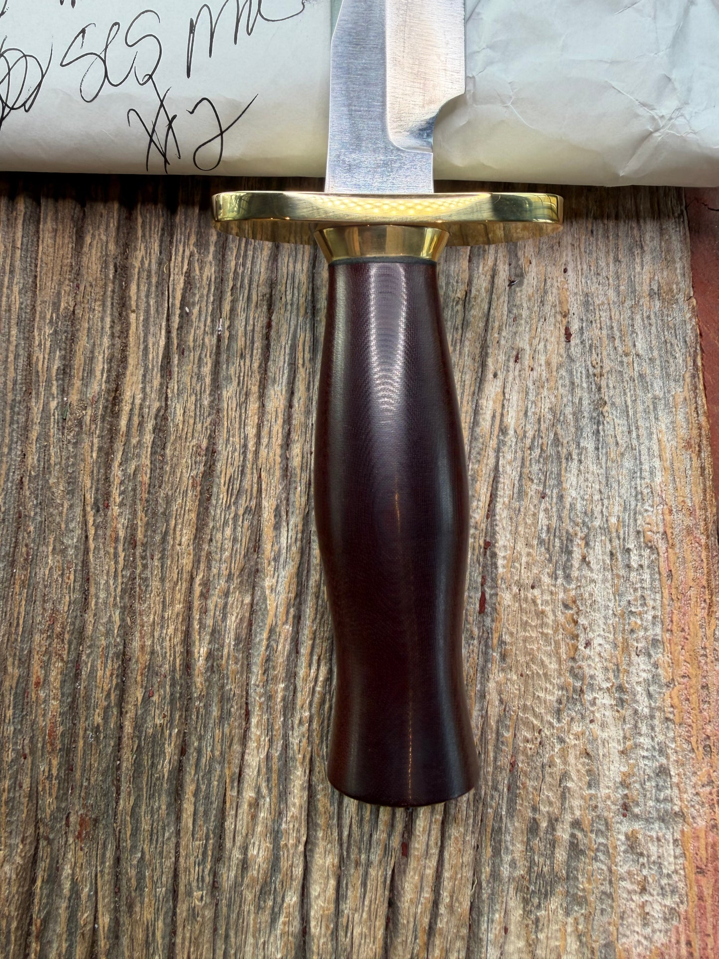 New in Paper Randall Model 12-6 Little Bear with a Maroon Micarta handle. Brass Hilt  and Brass collar Carbon steel, natural end.