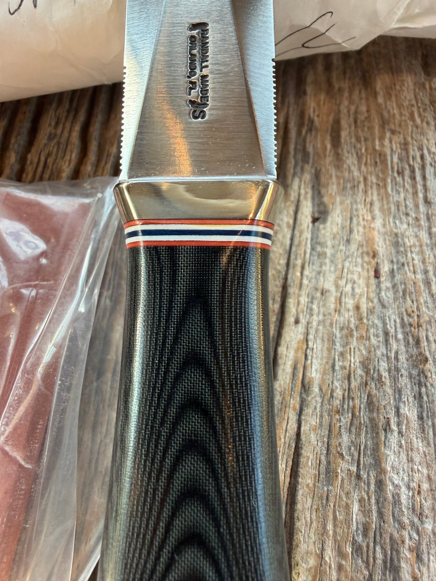 New in Paper Randall Model 24 Guardian in Black Micarta Nickel hilt, Stainless, red white blue spacers.