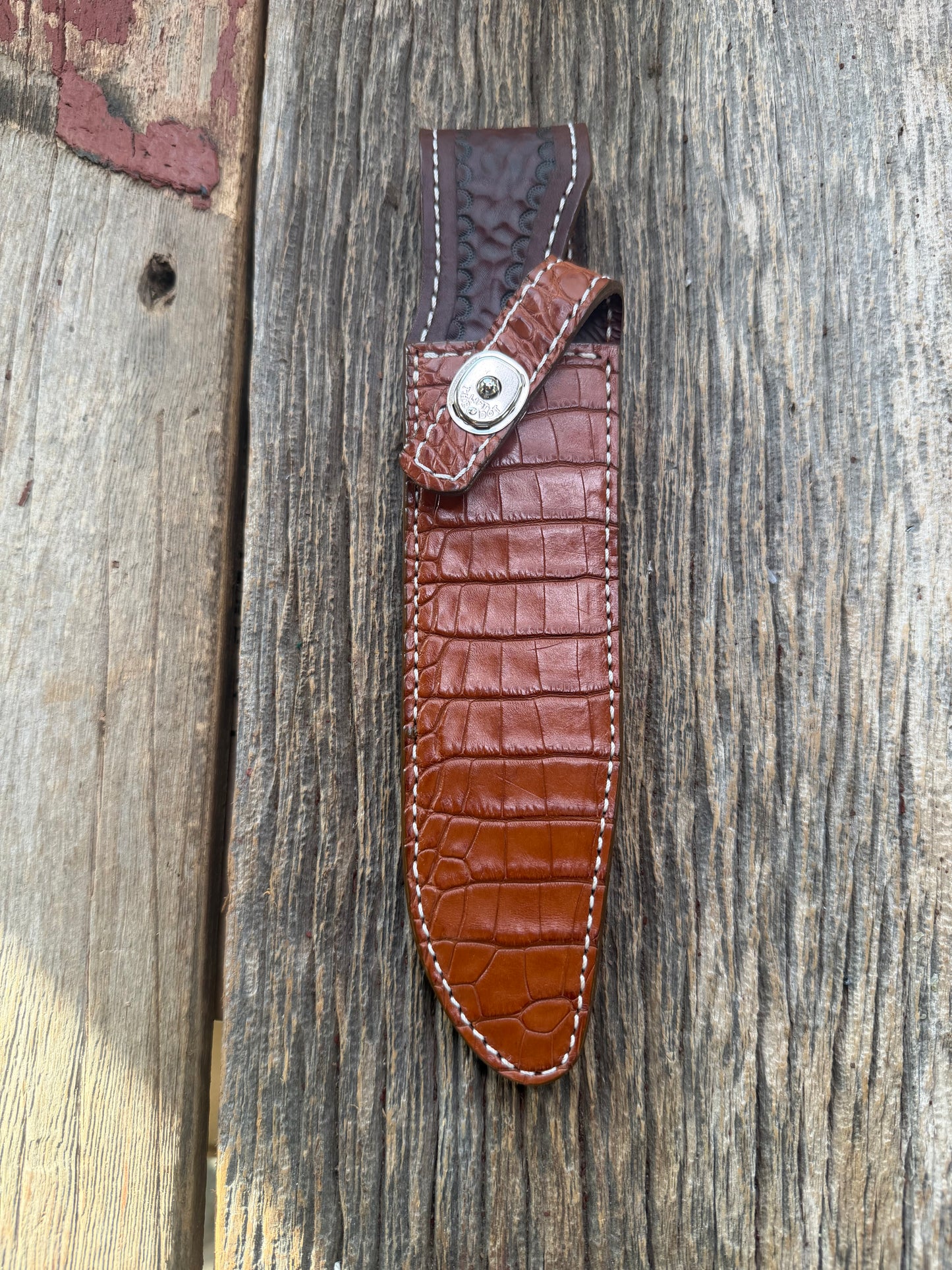 New Randall Model 1-7 Sheath in Exotic thick and textured Honey Crocodile skin on brown leather from Treeman with a silver Canteen snap. Hand tooled belt loop. Killer sheath.