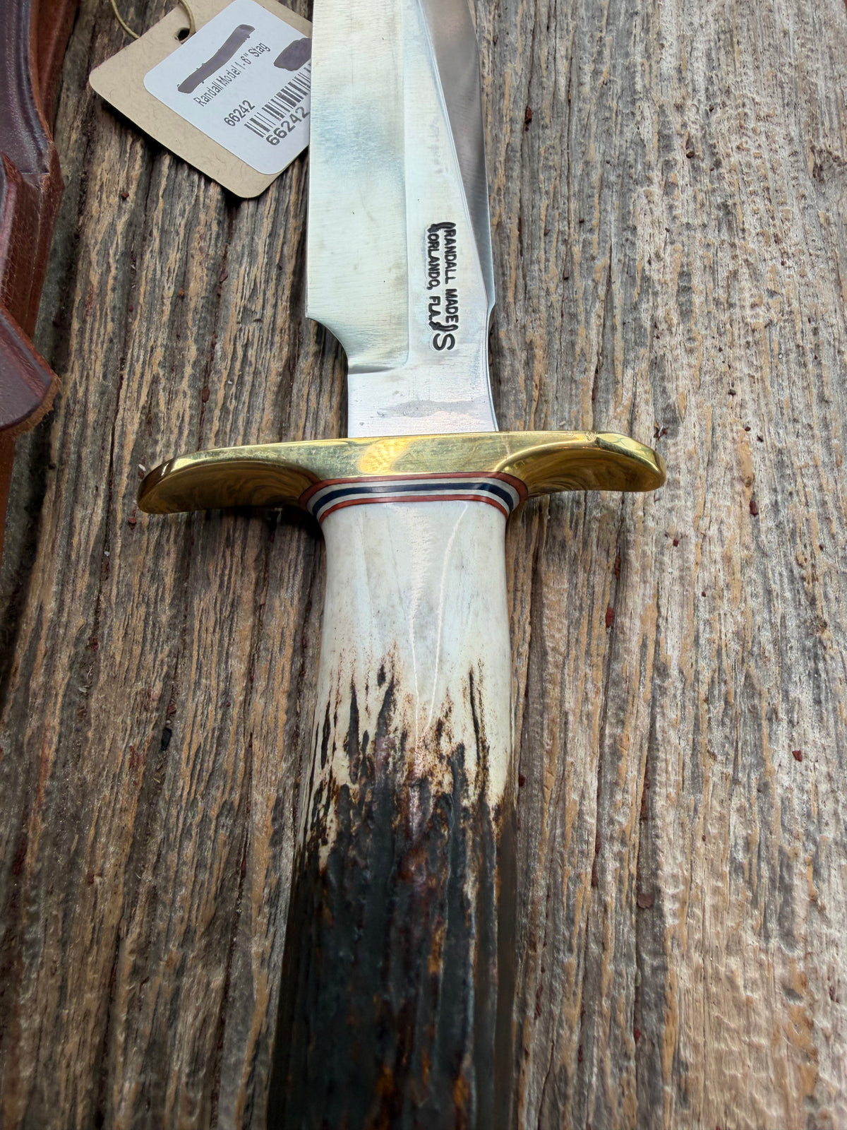 New Randall Model 1-6 with a Stag handle. Stainless steel blade, brass hilt and natural butt. Red white and Blue spacers.