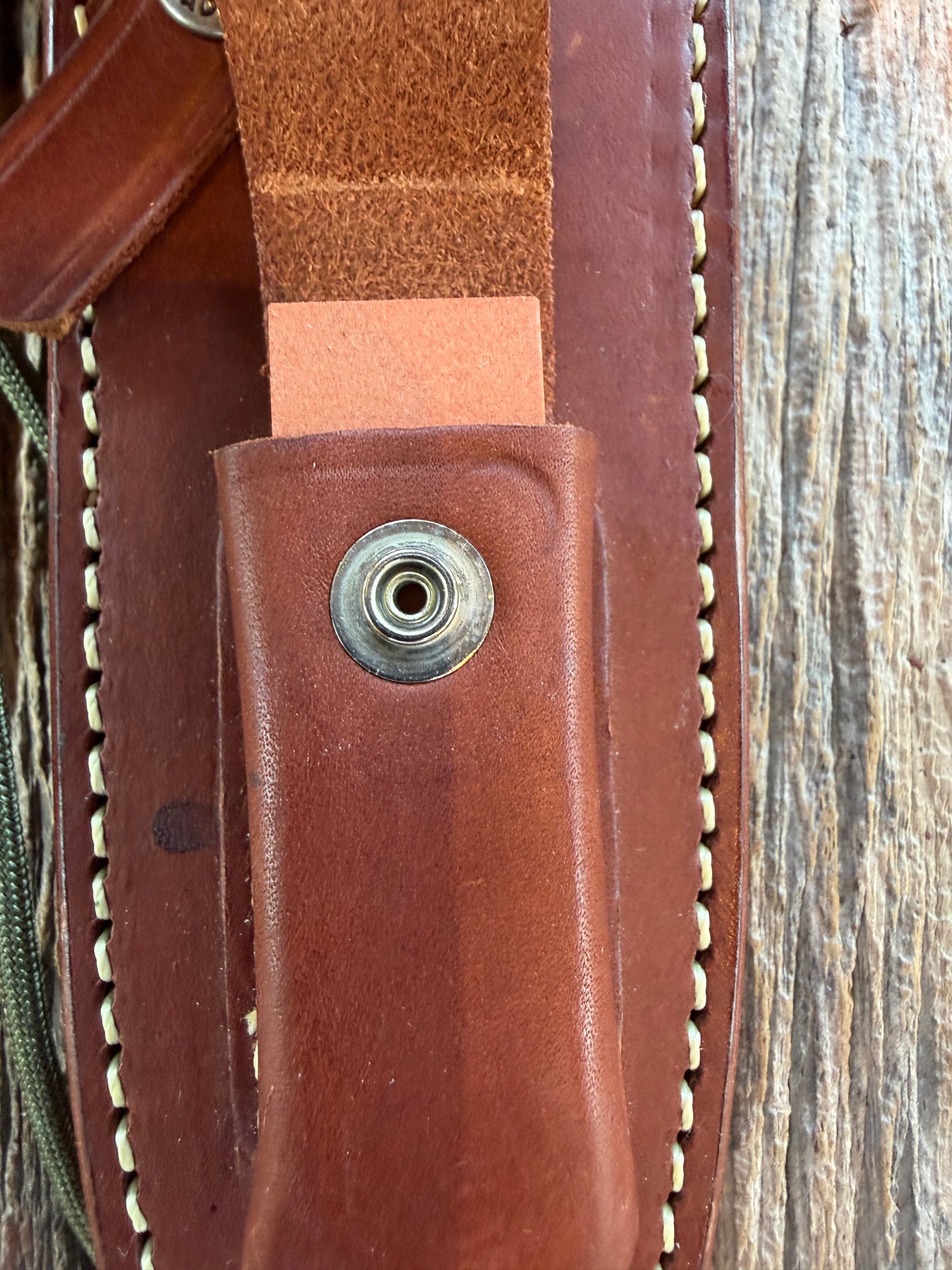 Mint Randall by Gutcher Knife Sheath for a Model Buxton Fighter. Randall snaps, double stitched, pouch with stone, lanyards straps as well.