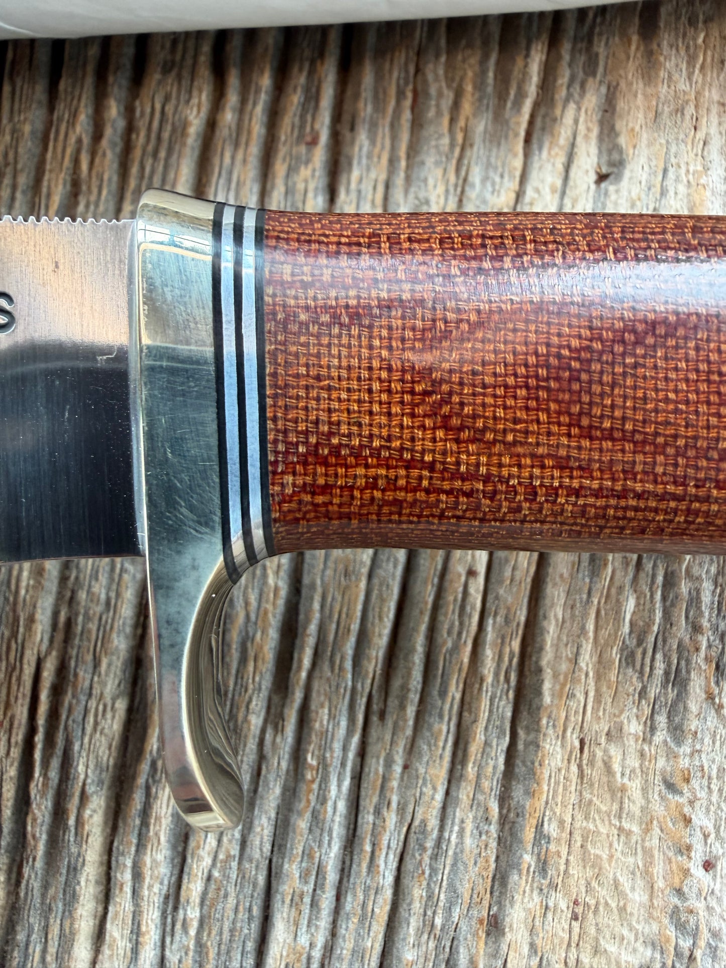 New in Paper Randall Model 19-5 Bushmaster with an Brown Micarta handle. SS blade, Nickel silver single hilt. Lanyard. Brown leather sheath.