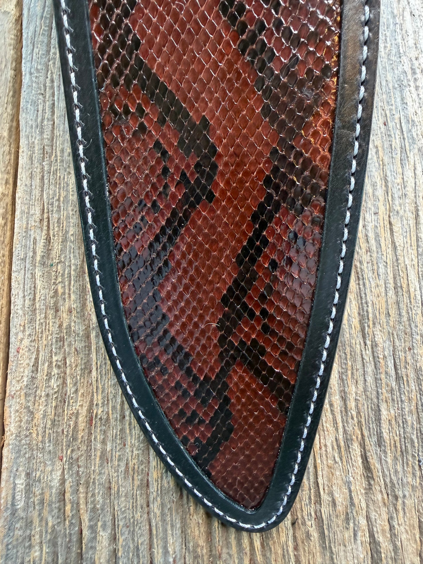 New Randall Model 12-11 Large Sasquatch Sheath in Exotic Brown Python Snake on black leather from Treeman with a black Canteen snap. Hand tooled belt loop. Deviated white stitching. Killer sheath.