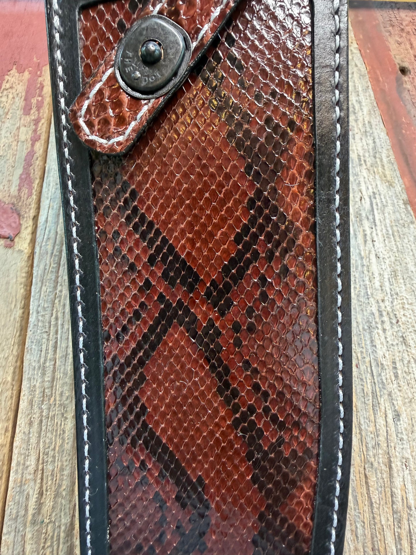 New Randall Model 12-11 Large Sasquatch Sheath in Exotic Brown Python Snake on black leather from Treeman with a black Canteen snap. Hand tooled belt loop. Deviated white stitching. Killer sheath.
