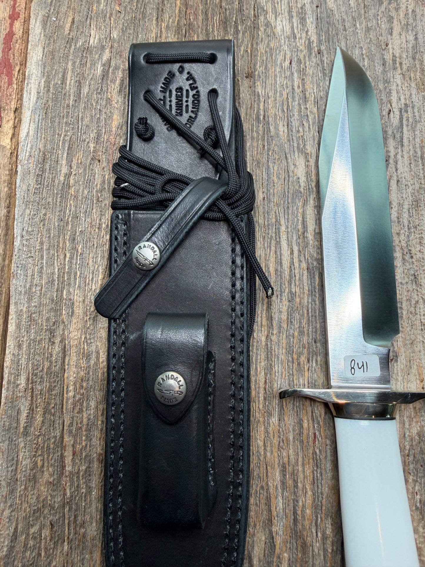 Randall Model 14-7.5 with a White Ivorite handle. Stainless steel blade, Nickel silver hilt and collar. Upgraded Black leather sheath.  Roundsd Aluminum butt cap.