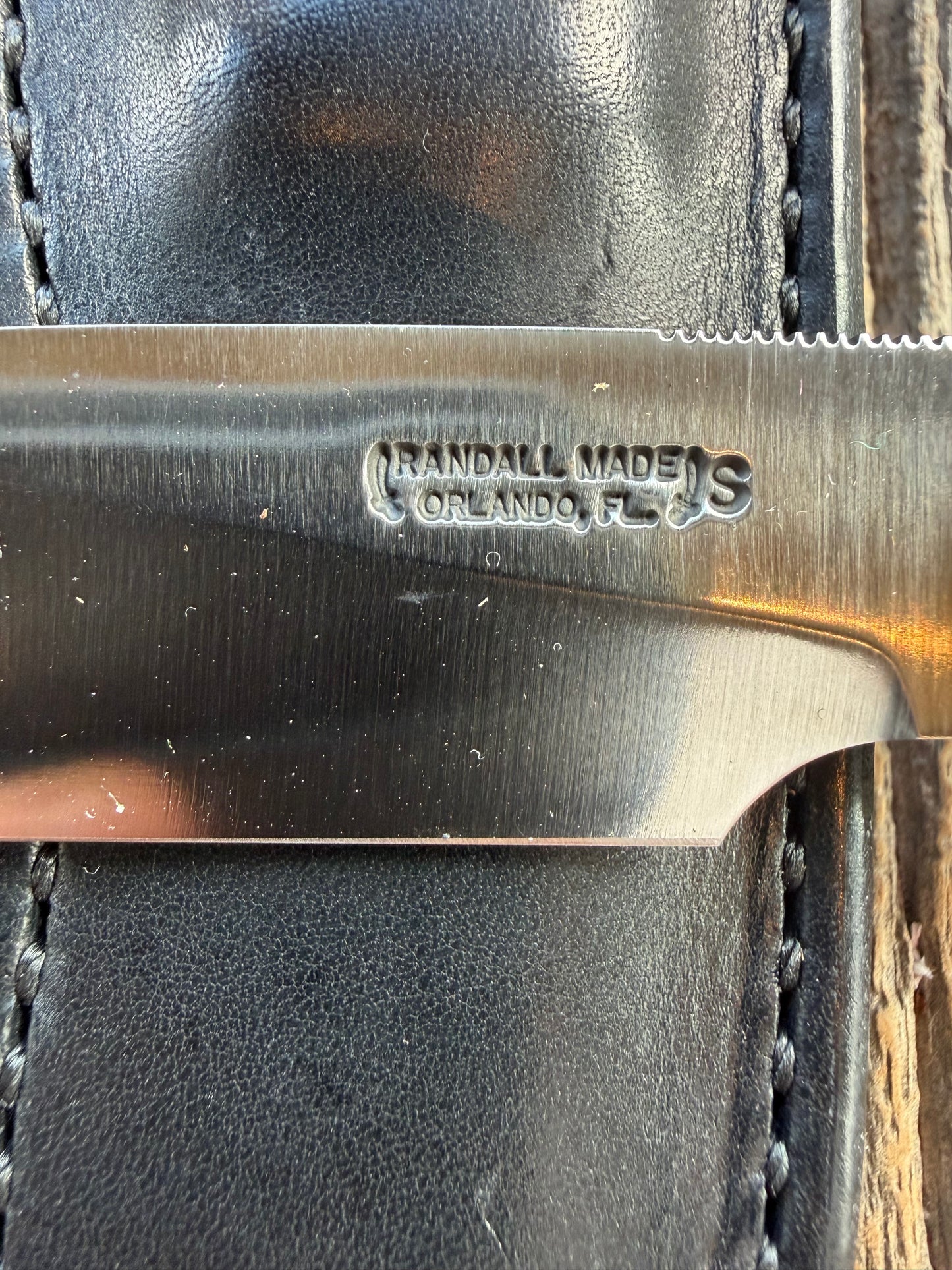 New in Paper Randall Non Catalog Model  Cattleman. White Ivorite handle. Red and silver spacers. Stainless blade.