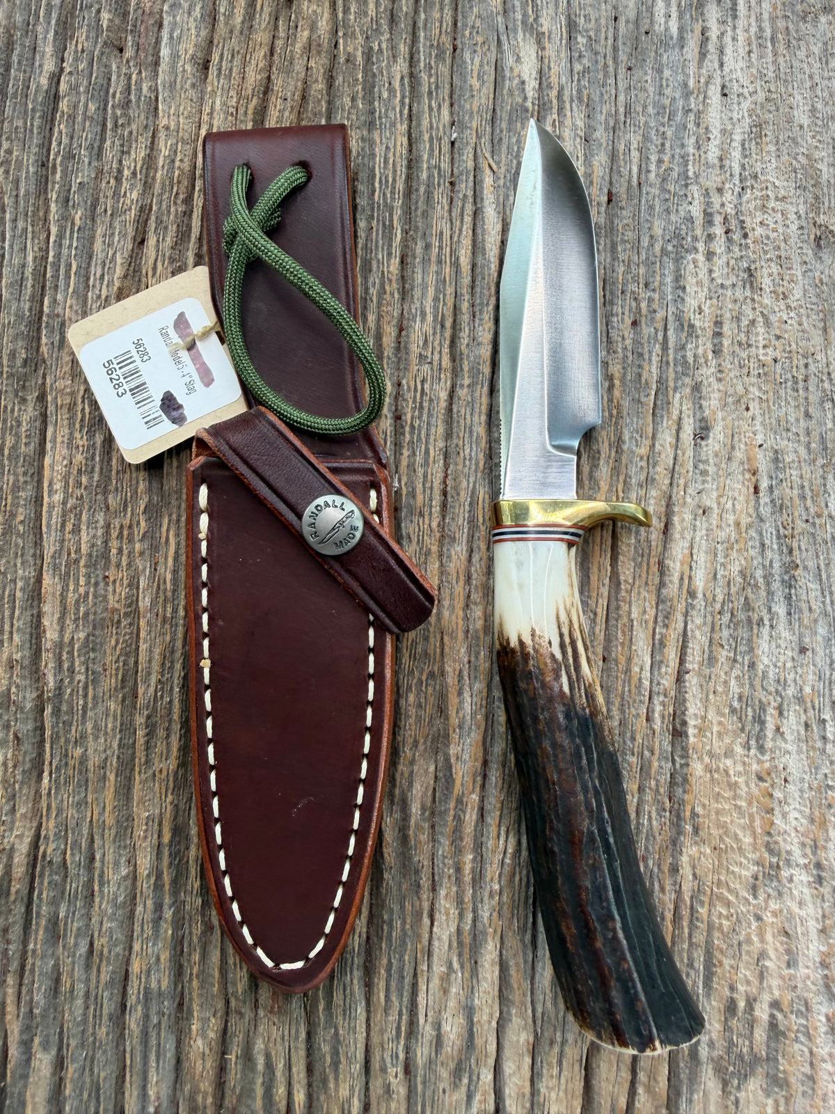 New Randall Model 5-4 with a Stag handle. Stainless steel blade, brass single hilt and natural butt. Red white and Blue spacers.