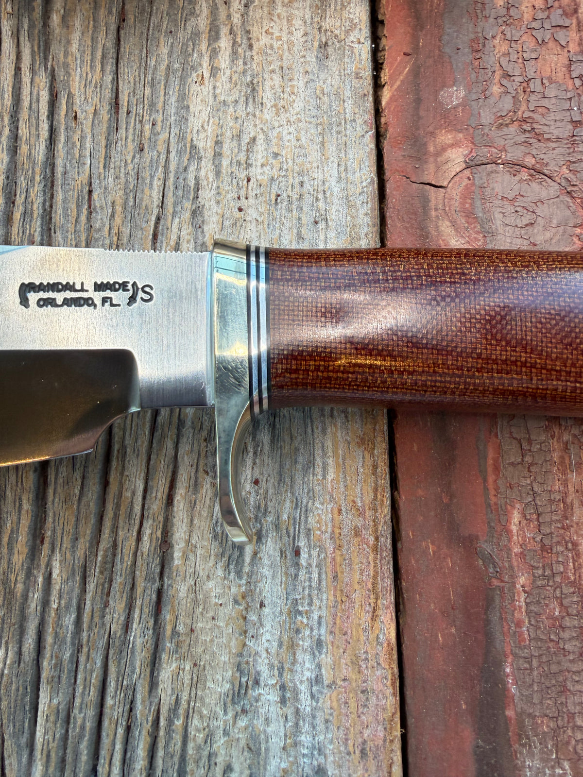 New in Paper Randall Model 19-5 with an attractive piece of Brown Micarta. Nickel silver single Hilt and buttcap , Stainless steel. Black and Aluminum spacers.