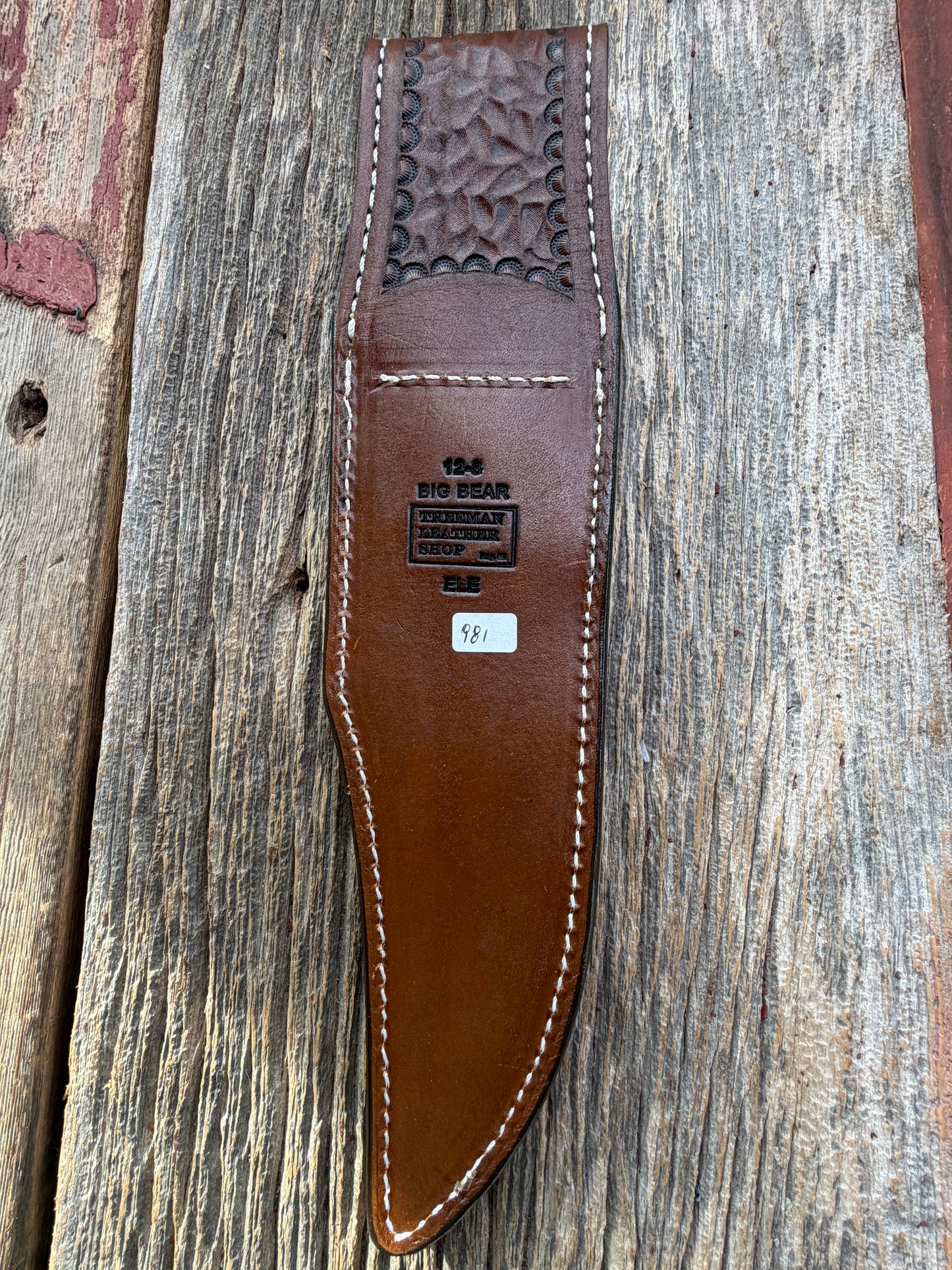 New Randall Model 27 Sheath in Exotic thick and textured Black and Grey Elephant Ear  on brown leather from Treeman with a black Canteen snap. Hand tooled belt loop. Killer sheath.