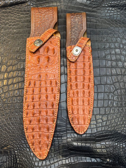 A pair of Randall Model 12-11 Large Sasquatch (Skull) and Randall Model 12-8 Small Sasquatch ( middle back) Sheaths in Exotic Tan Hornback Crocodile by Treeman.