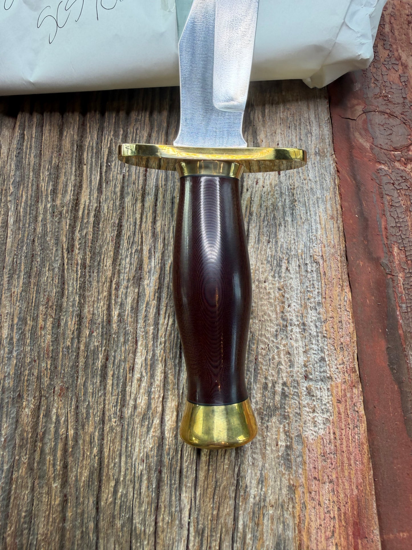 New in Paper Randall Model 12-8 Big Bear with a Maroon Micarta handle. Brass Hilt  and Brass collar, Carbon steel, brass butt cap.