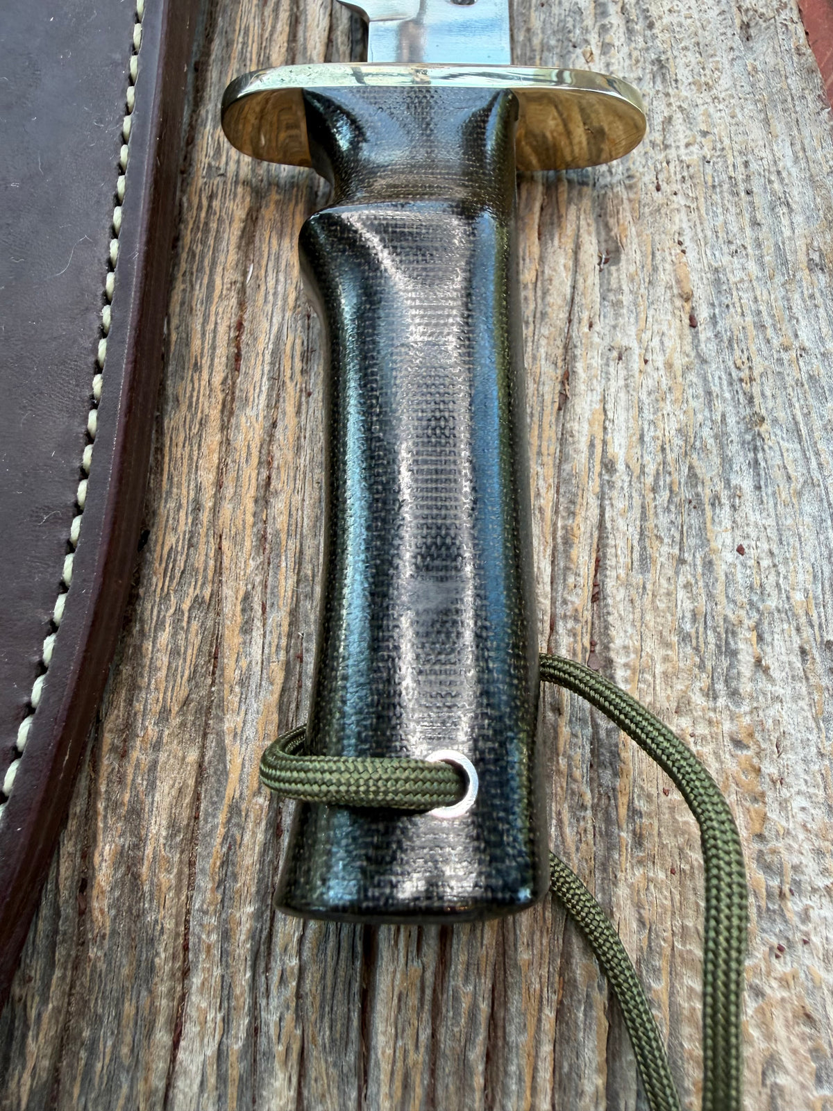 Nice Randall Model 16-7 with a glossy Brown Micarta handle. SS blade, double nickel silver hilt. Lanyard. Sawteeth, Brown waxed leather sheath.