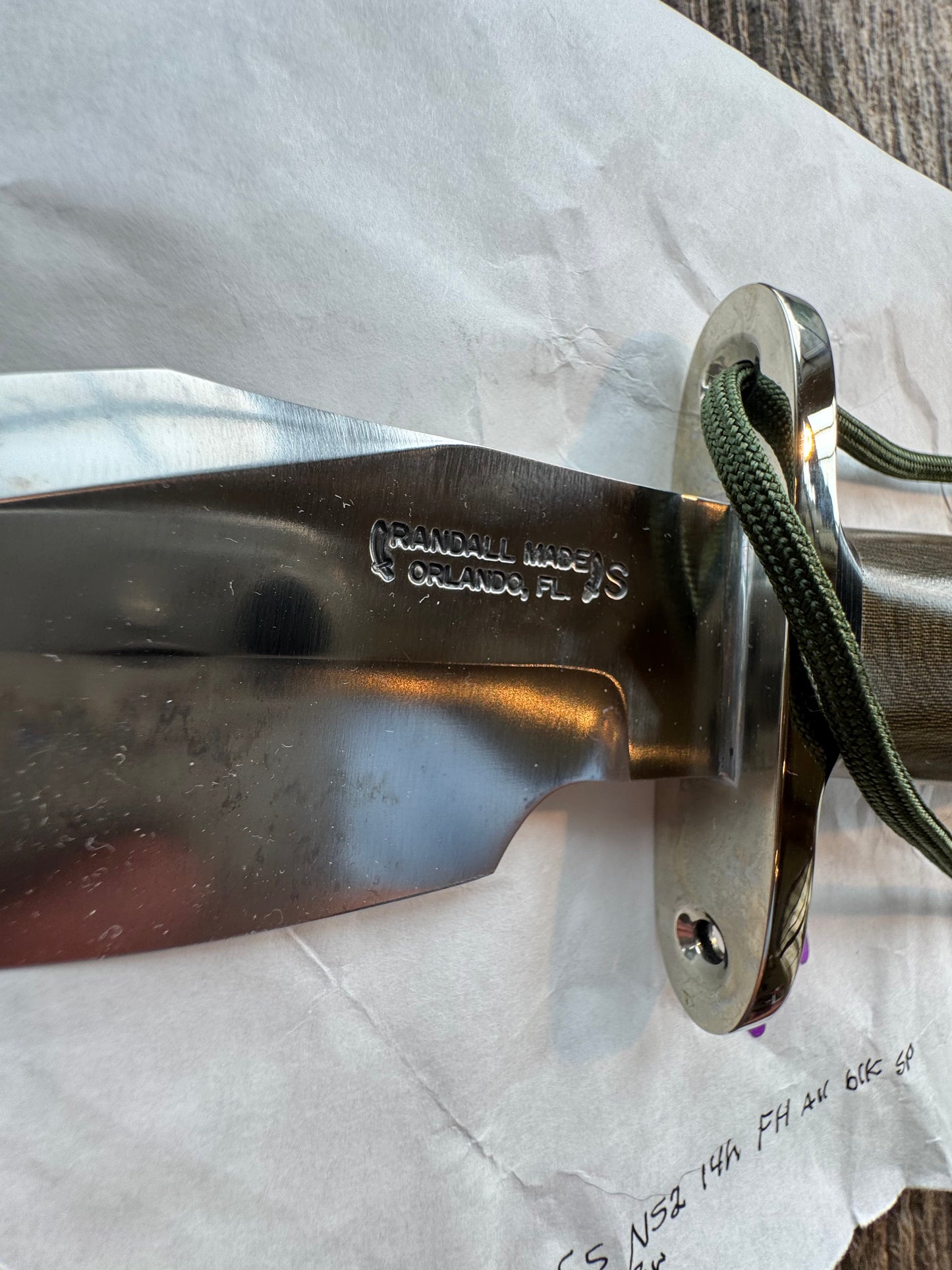 New in Paper Randall Model 19-5 Bushmaster with an Green Micarta handle. SS blade, Nickel silver single hilt. Lanyard. Brown leather sheath.