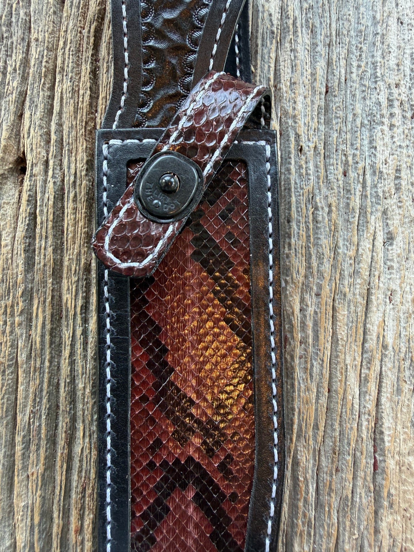 New Randall Model 1-7 Sheath in Exotic Brown Python Snake skin on black leather from Treeman with a black Canteen snap. Hand tooled belt loop. Deviated white stitching. Killer sheath.