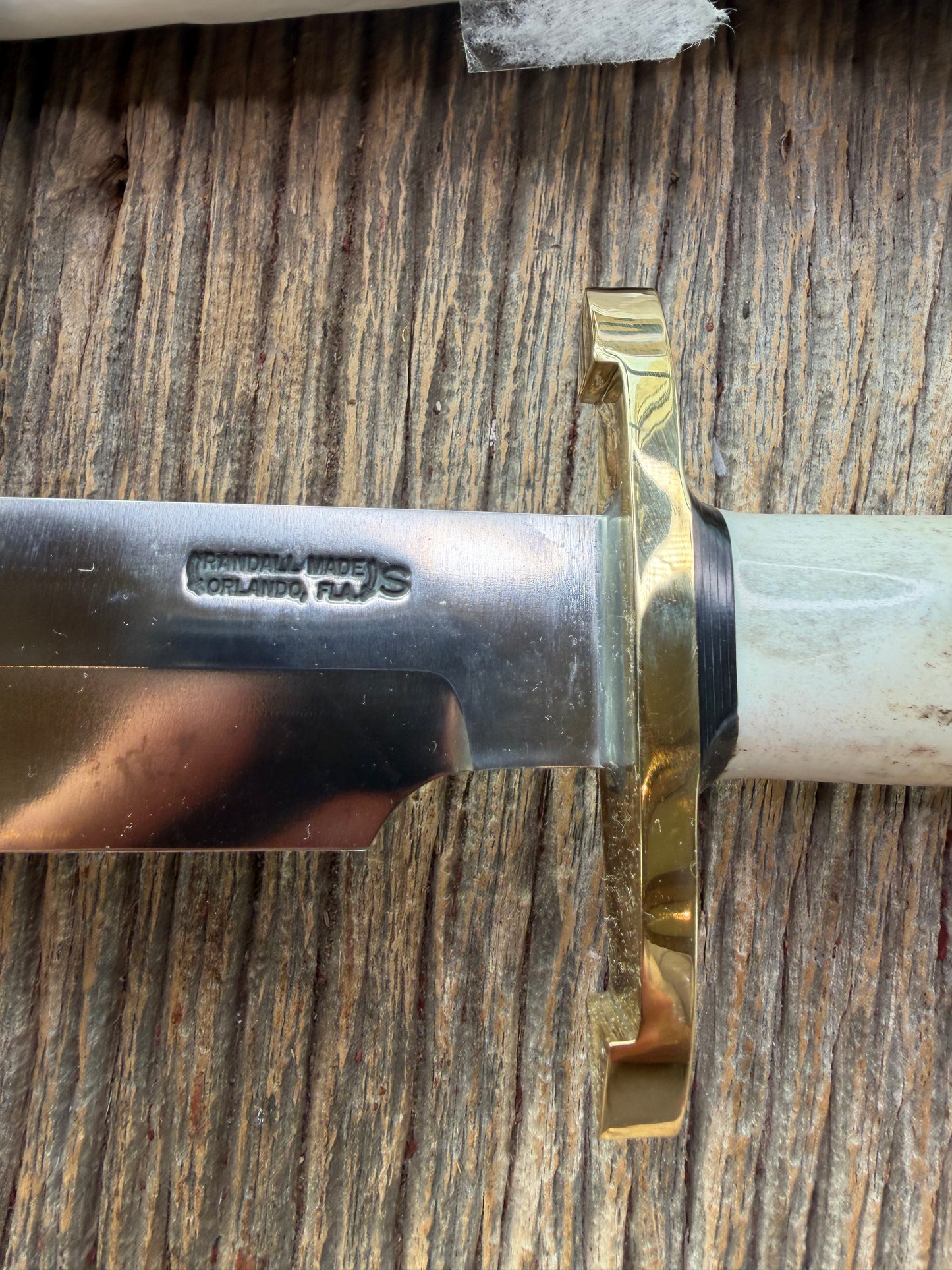 New in paper fresh from the Shop. Randall Knife Model 14-7.5 Big. Nice piece of Stag, Gorgeous Brass Lugged hilt and brass crows beak butt cap. Single black spacer. Stainless steel.