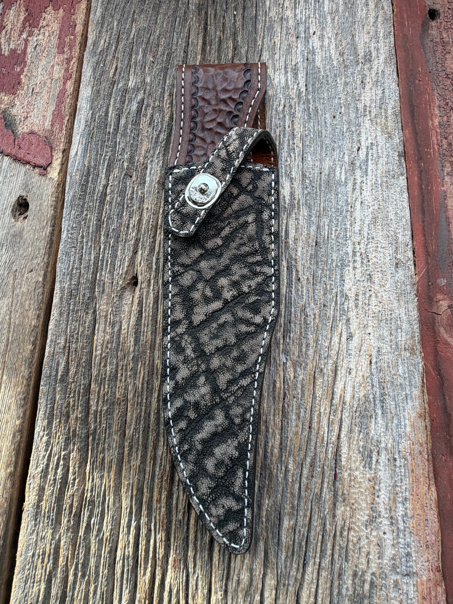 New Randall Model 27 Sheath in Exotic thick and textured Black and Grey Elephant Ear  on brown leather from Treeman with a black Canteen snap. Hand tooled belt loop. Killer sheath.