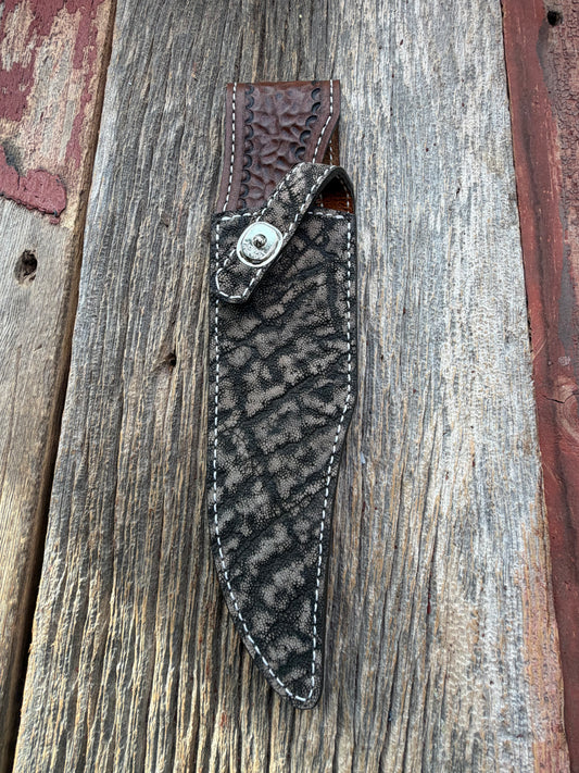 New Randall Model 27 Sheath in Exotic thick and textured Black and Grey Elephant Ear  on brown leather from Treeman with a black Canteen snap. Hand tooled belt loop. Killer sheath.