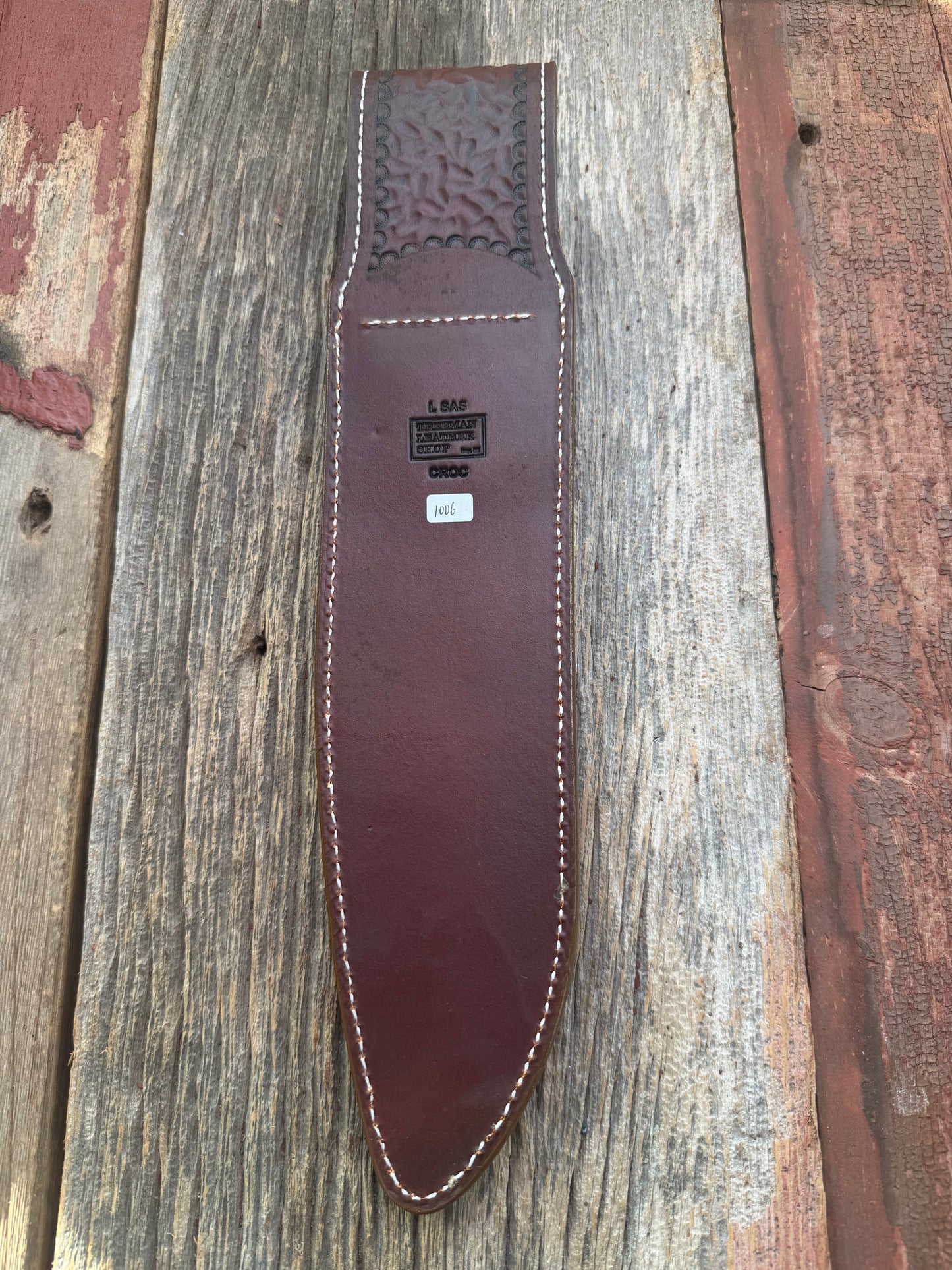 New Randall Model 12-11 Large Sasquatch Sheath in Exotic thick and textured Honey Crocodile skin ( skull portion) on brown leather from Treeman with a silver Canteen snap. Hand tooled belt loop. Killer sheath.