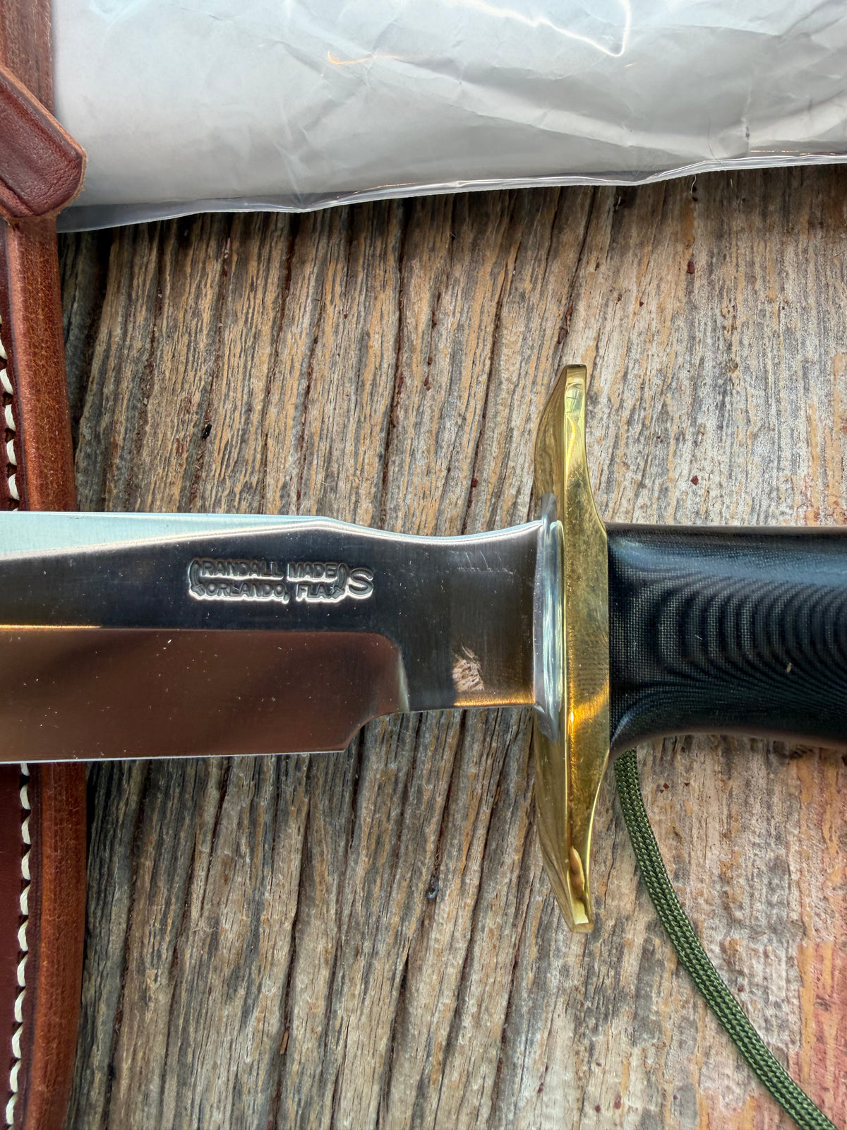 New in paper Randall Model 16 SP#1 Special fighter with a Black Micarta handle. SS blade, brass hilt. Lanyard. Brown leather sheath.