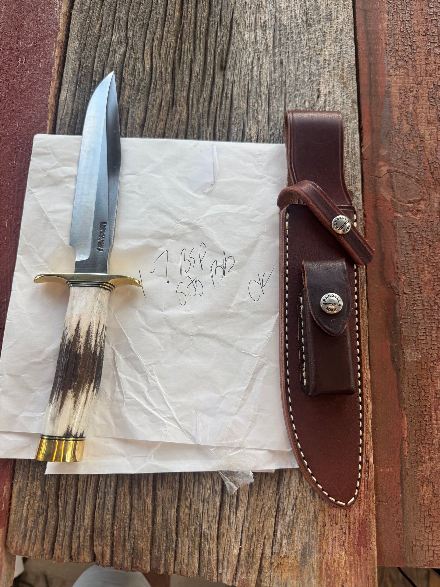 New in Paper Randall Knife Model 1-7 in Stag, Brass Hilt and Butt Cap, Black and Gold spacers.